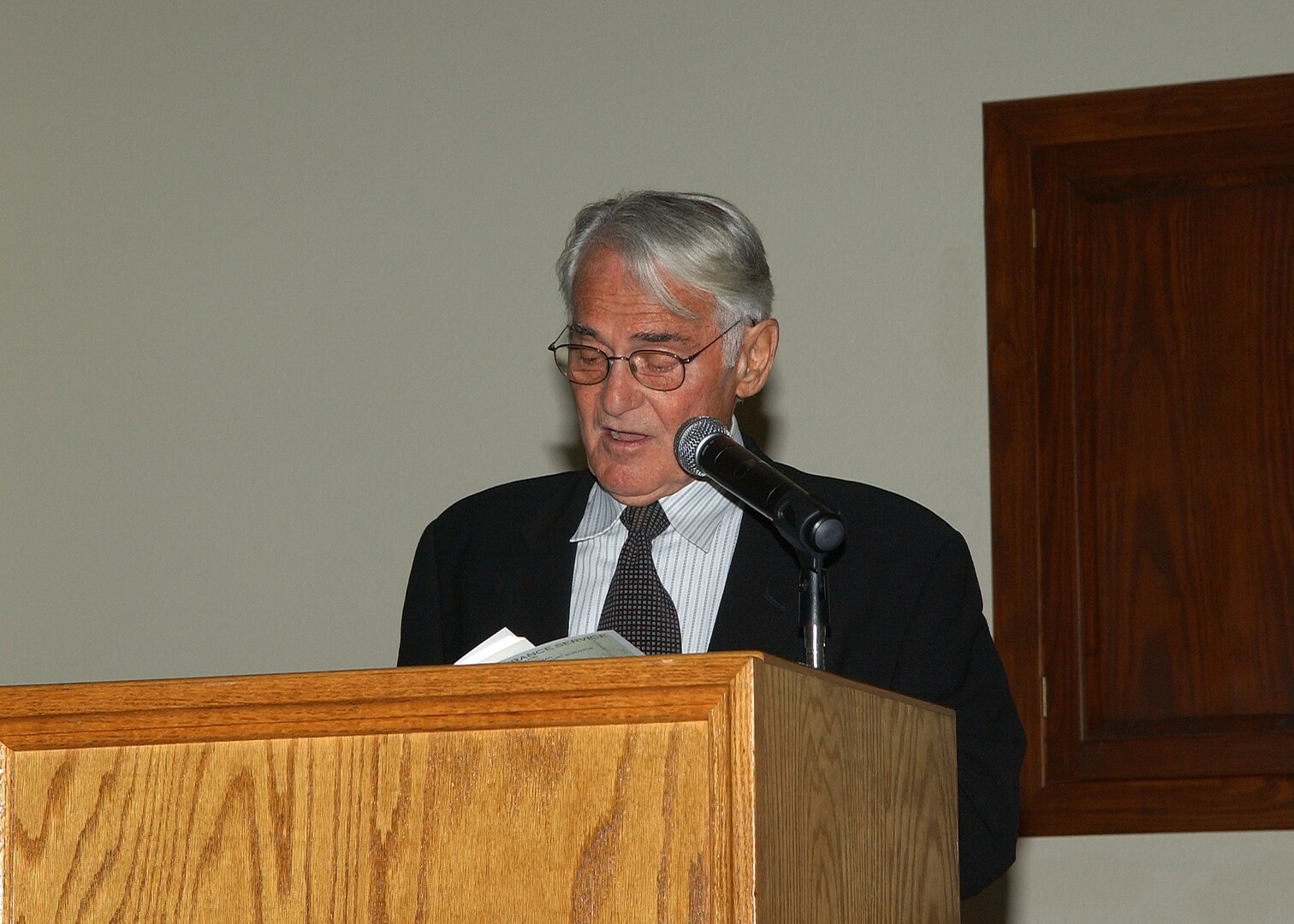 William Samelson, a visiting professor of Holocaust and Genocide Studies at the University of Texas in San Antonio and Trinity University, reads a poem during a Holocaust Remembrance Service April 15 at Lackland Air Force Base, Texas. The poem honors his mother who died during the Holocaust. Dr. Samelson was 11 years old when he was captured by the Nazis and taken to Buchenwald Concentration Camp. He spent three-and-a-half years there. About 57 members of his family perished in concentration camps. (USAF photo by Alan Boedeker)                               