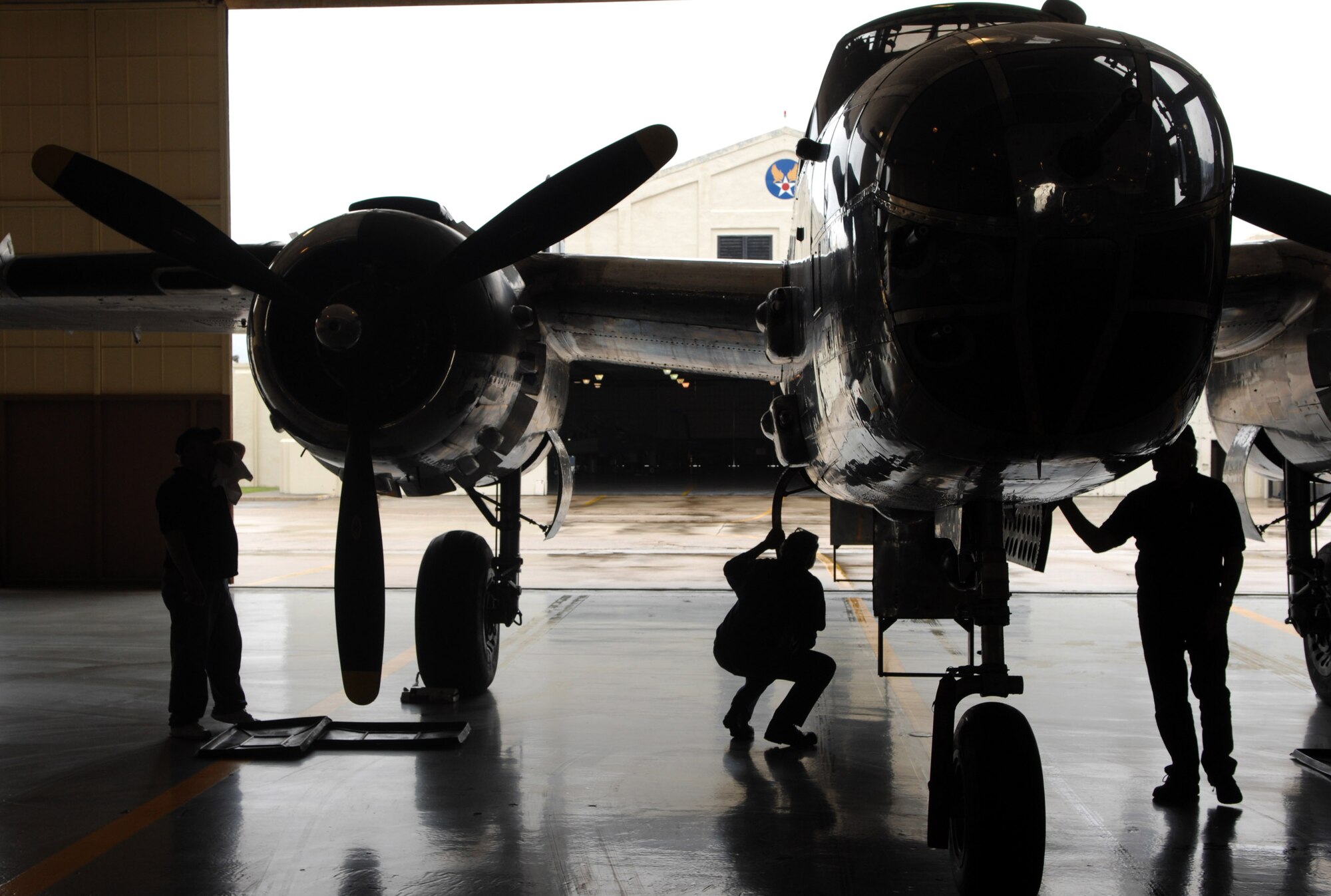 Maintenance workers wipe down a B-25 Mitchell on display April 17 at Randolph Air Force Base, Texas. The plane was the backdrop for a ceremony honoring the Doolittle Raiders and the 65th Anniversary of the Doolittle raid. (U.S. Air Force photo/Staff Sgt. Brian Ferguson)