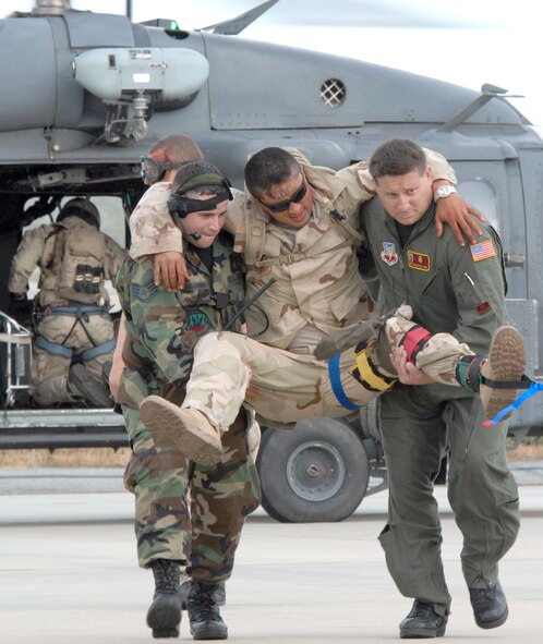 Staff Sgt. Ray Vazquez and Tech. Sgt. Kent Willette, 38th Rescue Squadron independent duty medical technicians, perform a transload of a simulated patient from an HH-60G Pave Hawk to a HC-130 during an exercise here April 11. The 38th RQS Operational Support Medical Flight, which includes flight surgeons, independent duty medical technicians and a medical logistician, organize, train and equip the pararescuemen they support. (U.S. Air Force photo by Airman 1st Class Gina Chiaverotti)