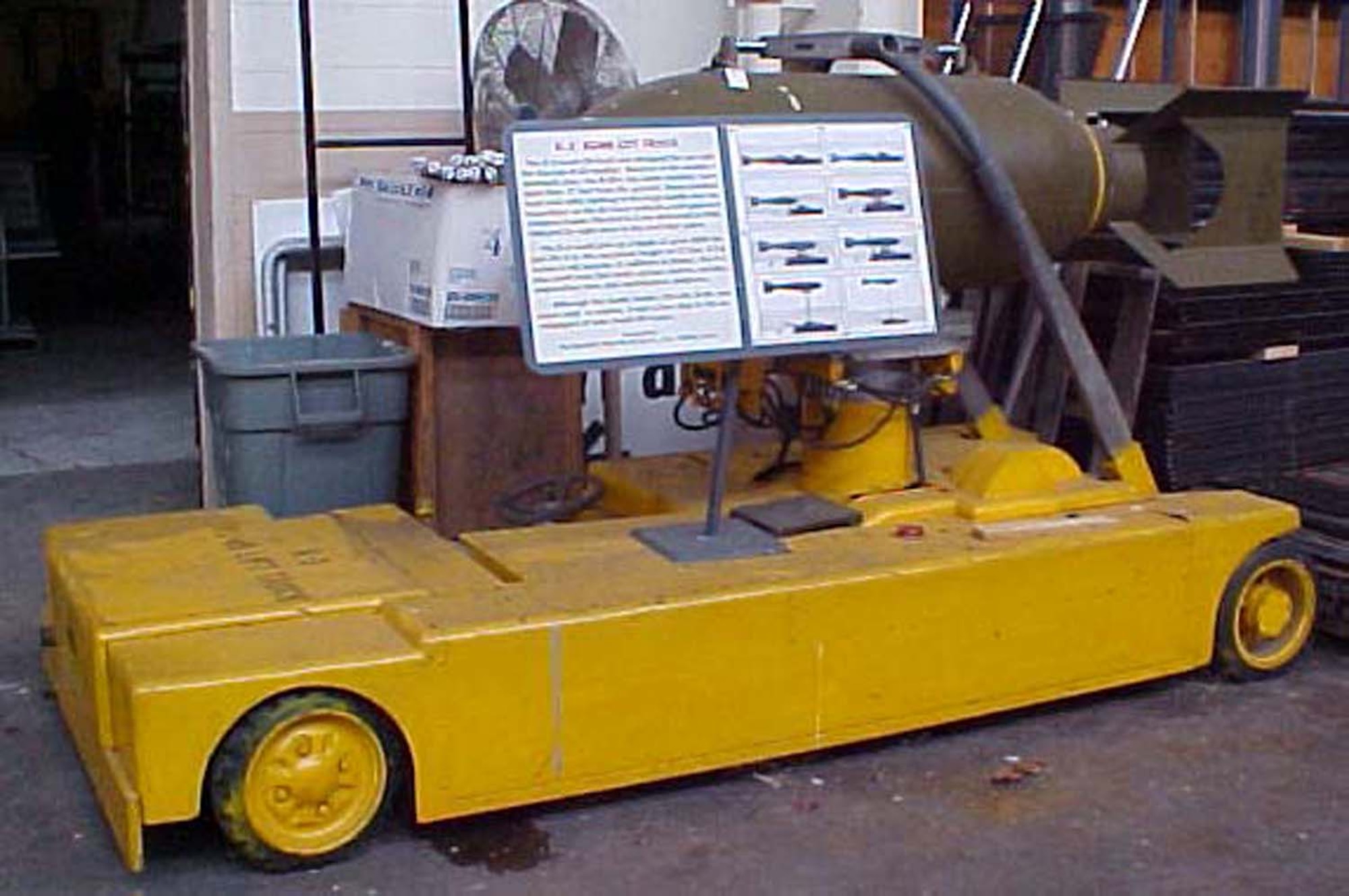 The K-3 bomb lift truck was designed for use with the Convair B-36 bomber. Because of the bomber's mammoth size, the B-36's top bomb shackles were more than 17 feet from the ground. Hand-cranked hoist and cable loading of the large bombs was too hazardous, so the Air Force ordered a self-powered weapons loader. (U.S. Air Force photo)