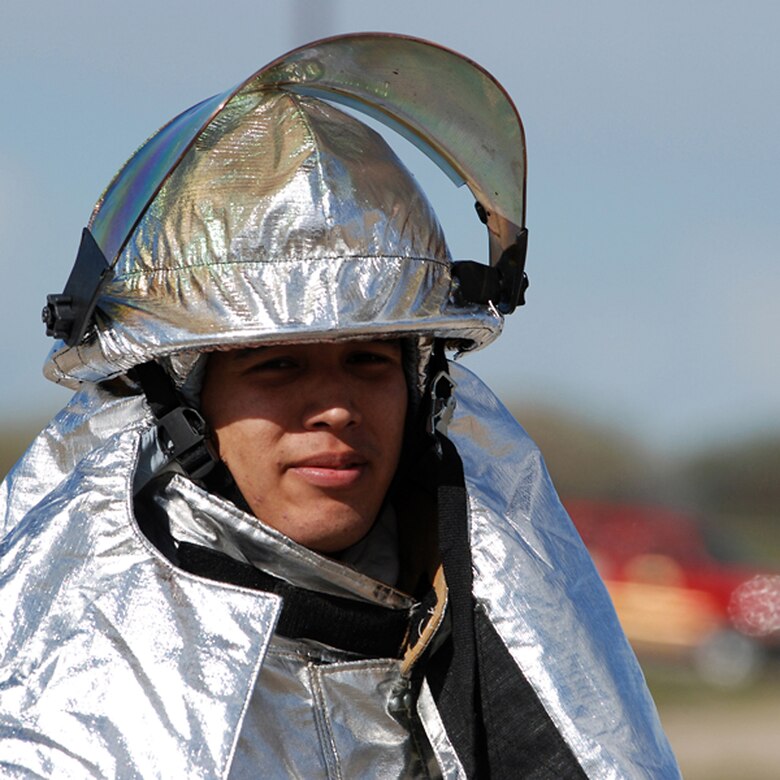 Airmen 1st Class Alex Smith, a 22nd Civil Engineer Squadron firefighter, prepares to extinguish a fire in an aircraft simulator, April 11, during a live-fire training exercise on McConnell. The exercise marked Airman Smith’s first live-fire training experience here. Firefighters from the 22nd Civil Engineer Squadron and the Kansas Air National Guard participated in the exercise. (Photo by Airman 1st Class Jessica Lockoski)