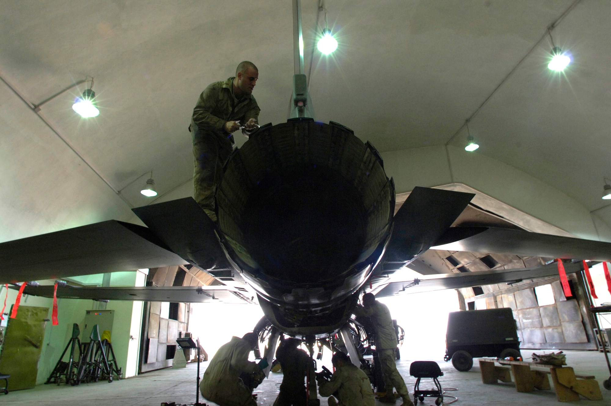 BALAD AIR BASE, Iraq -- Staff Sgt. Justin Johnson, 332nd Expeditionary Maintenance Squadron phase inspection team member, removes screws off of an F-16 rudder. Sergeant Johnson is deployed here with other Misawa Airmen from the 35th Aircraft Maintenance Squadron. (U.S. Air Force photo/Airman 1st Class Nathan Doza)