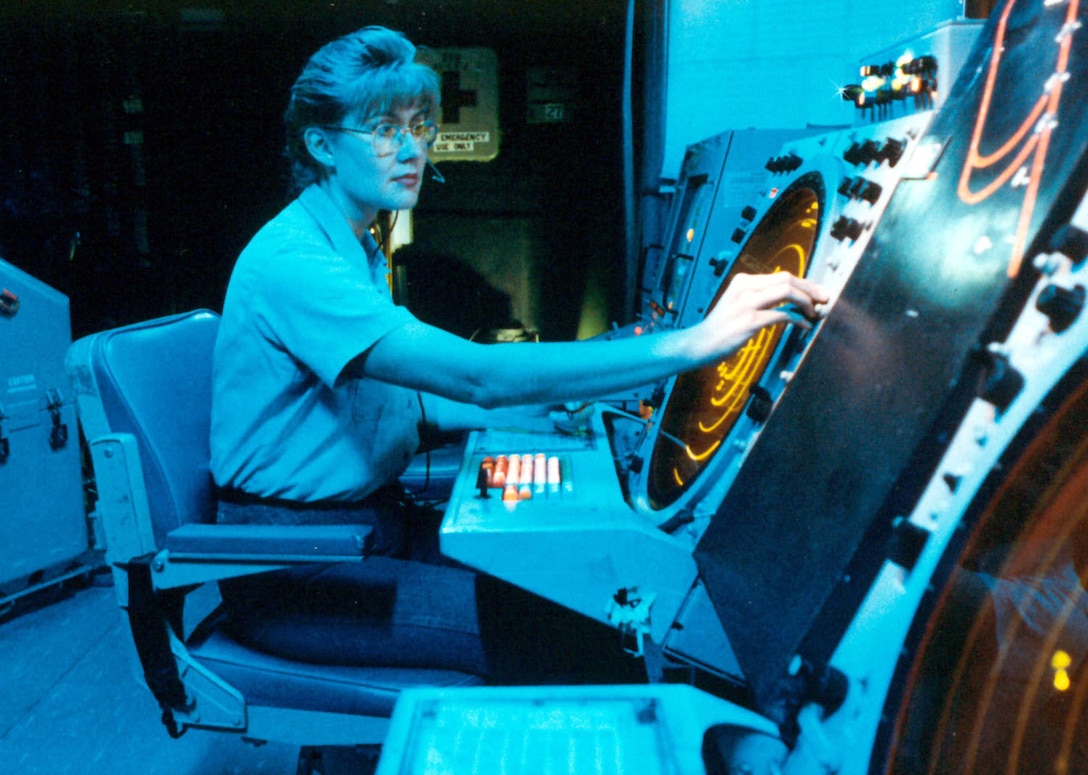 Air traffic controller Petty Officer 2nd Class Jamie Bradley works at the Carrier Air Traffic Control Center aboard the aircraft carrier USS Kitty Hawk while en route to the Persian Gulf. Petty Officer 3rd Class Mark Hamilton, USN