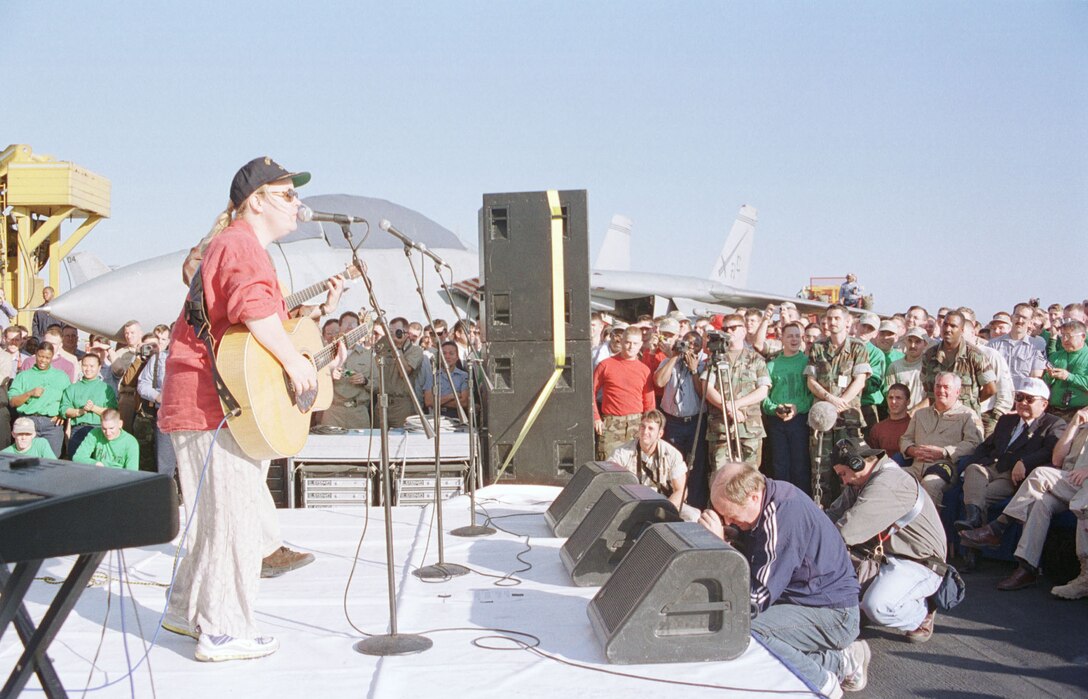 Mary Chapin Carpenter sings her hit song "I Feel Lucky" to the crew of the USS Enterprise during a visit to the ship Dec. 23. The Enterprise carrier battle group is currently leaving the Persian Gulf to continue its six-month deployment. (PH3 Jason D. Malcom, USN)