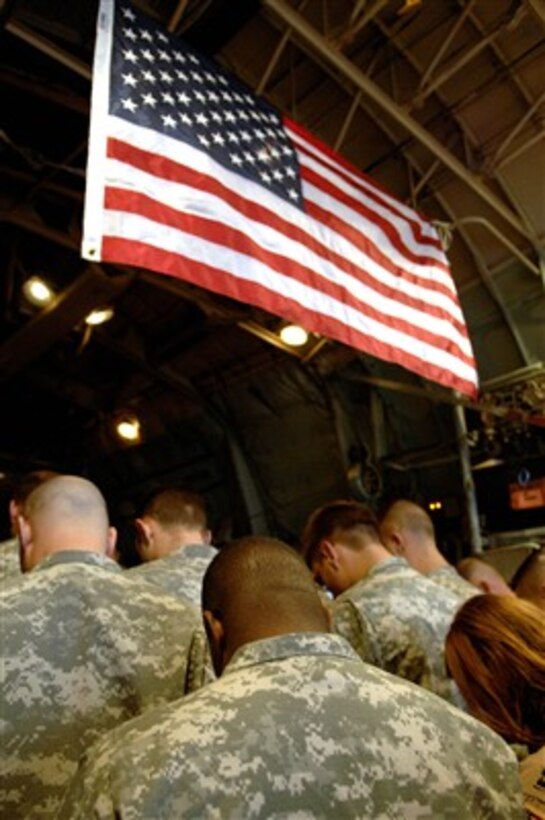 U.S. service members gather on the ramp of a C-130 Hercules aircraft to send off a fallen comrade at Balad Air Base, Iraq, on April 7, 2007.  