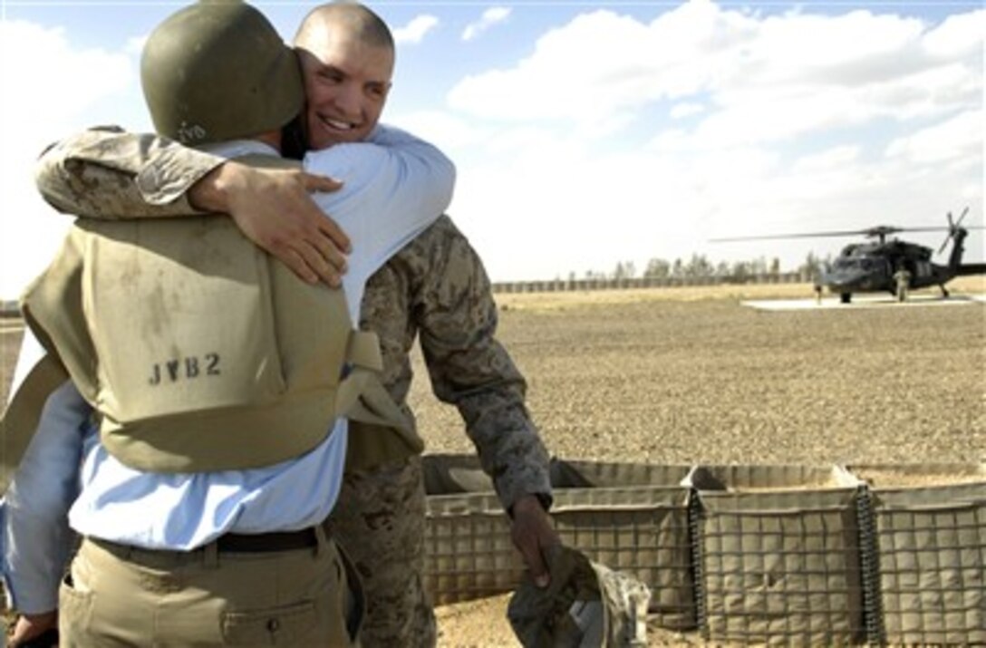 U.S. Marine 1st Lt. Kyle Opel, Transportation Command, Combat Logistics Battalion, Multinational Forces-Iraq West, hugs his father retired Marine Craig Opel, director of communication for the secretary of defense, at Camp Fallujah, Iraq, April 19, 2007. 