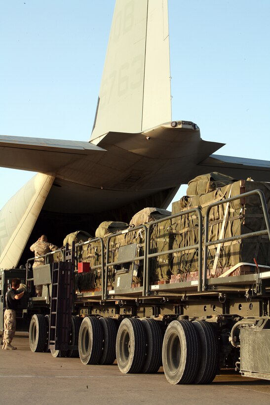 Marines and Airmen prepare to load cargo into the belly of a C-130 flown by Marine Aerial Refueling Squadron 352, April 21. (Photo by Cpl. Zachary Dyer)