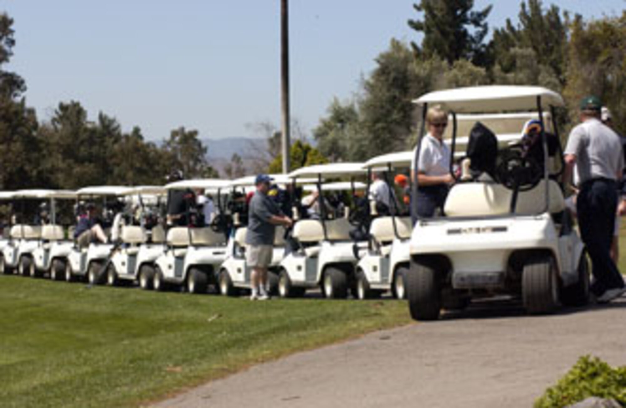The convoy of golf carts are ready to take off with Colonels Pamela, 452nd Mission
Support Group commander, and Cam, 452nd Maintenance Group commander,
LeBlanc leading the way. March Air Reserve Base captured the winner’s trophy at Broken Shaft Golf tournament against the Greater Riverside Chambers of Commerce. The Broken Shaft Tournament is an annual event between the two teams and this year, 52 people participated.  The base ended eight strokes ahead taking the low net total with 1903.  (U.S. Air Force photo by Staff Sgt. Amy Abbott, 452 AMW)