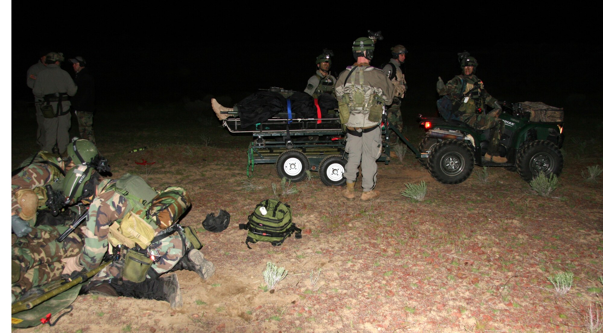After rescuing survivors from a simulated helicopter crash during a nighttime mass casualty training exercise near Pendleton, Ore., 304th Rescue Squadron pararescuemen transport them to a casualty collection point April 17, 2007.  (U.S. Air Force Photo/Master Sgt. Ruby Zarzyczny)