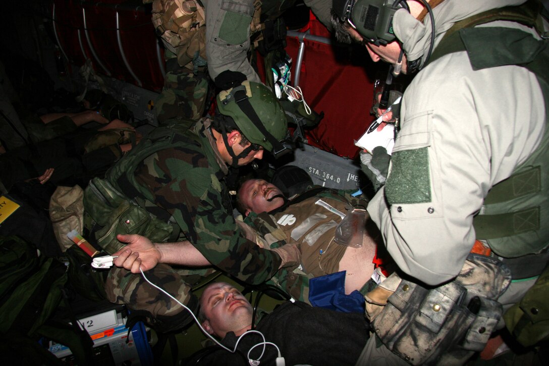After recovering survivors from a simulated helicopter crash during a nighttime mass casualty training exercise April 17, 2007, pararescuemen from the 304th Rescue Squadron, Portland, Ore. loaded them onto a CH-47 helicopter from the 1st Battalion 168th Aviation, Oregon Army National Guard, Pendleton Ore., and performed in-flight medical care.  (U.S. Air Force Photo/Master Sgt. Ruby Zarzyczny)