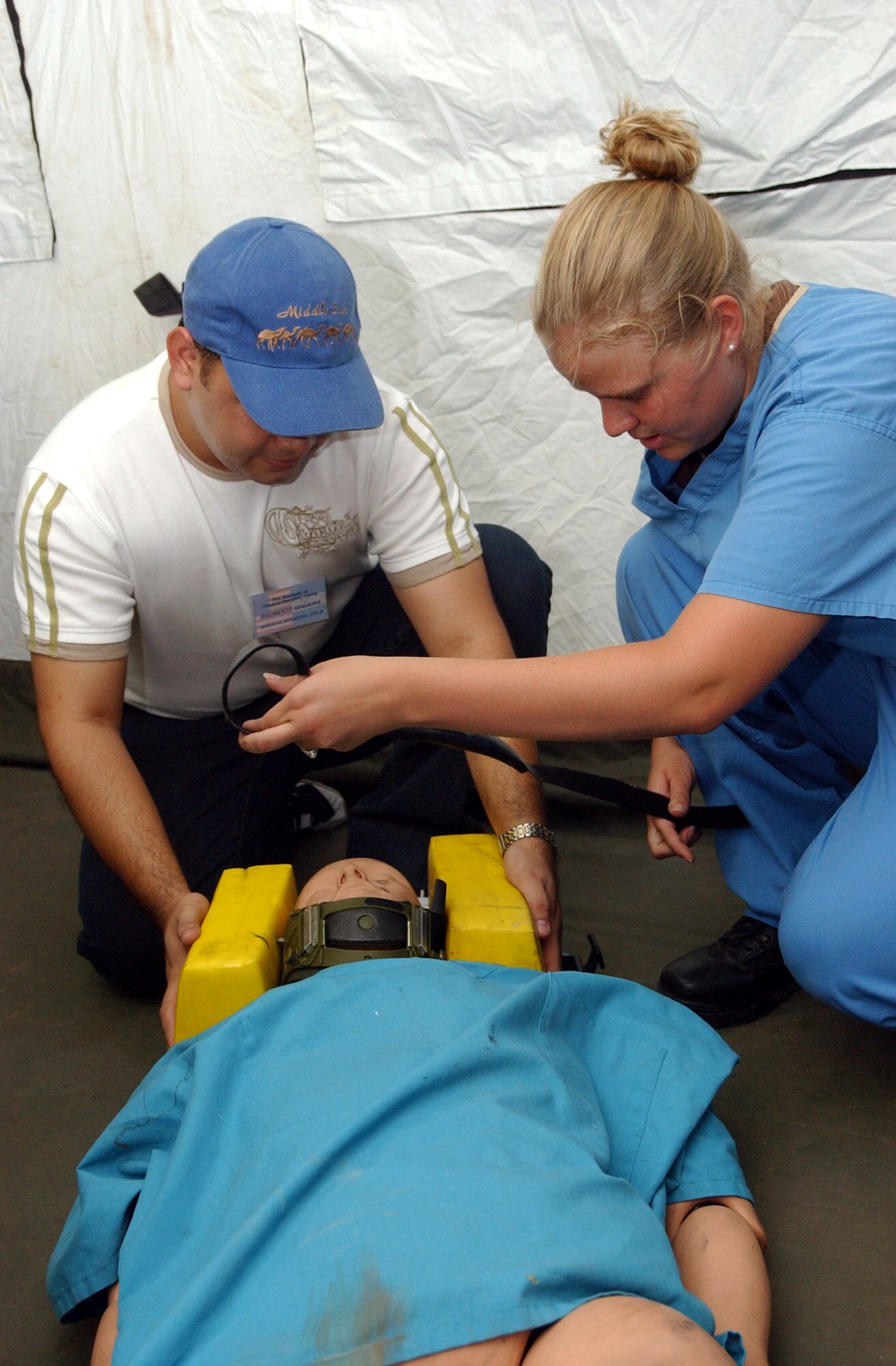 Senior Airman Jessica Laws explains how to stabilize a patient with a possible neck or spinal cord injury, during a major accident response exercise at Soto Cano Air Base, Honduras. Thirty eight students attended the class, which provided training on first aid techniques and chemical, biological, radiological, nuclear, and explosive readiness training. Airman Laws is with the Joint Task Force-Bravo's Medical Element. (U.S. Air Force photo/Tech. Sgt. Sonny Cohrs)