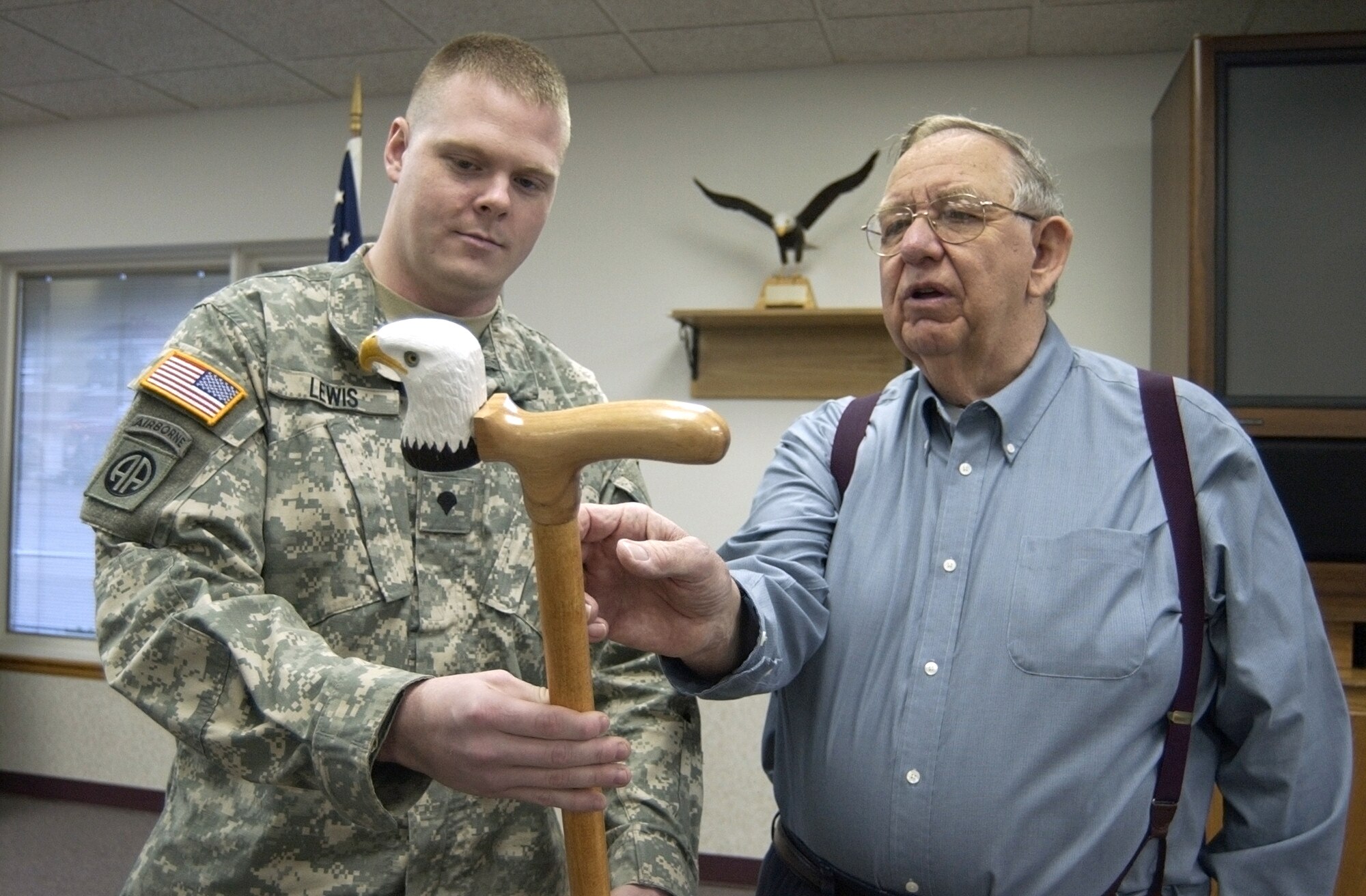 HUBER HEIGHTS, Ohio -- Army Spc. Thomas Lewis listens as Bill Wright, president of the Huber Heights Senior Citizens Center, describes the crafting of his eagle-headed cane.  (U.S. Air Force/Spencer P. Lane)