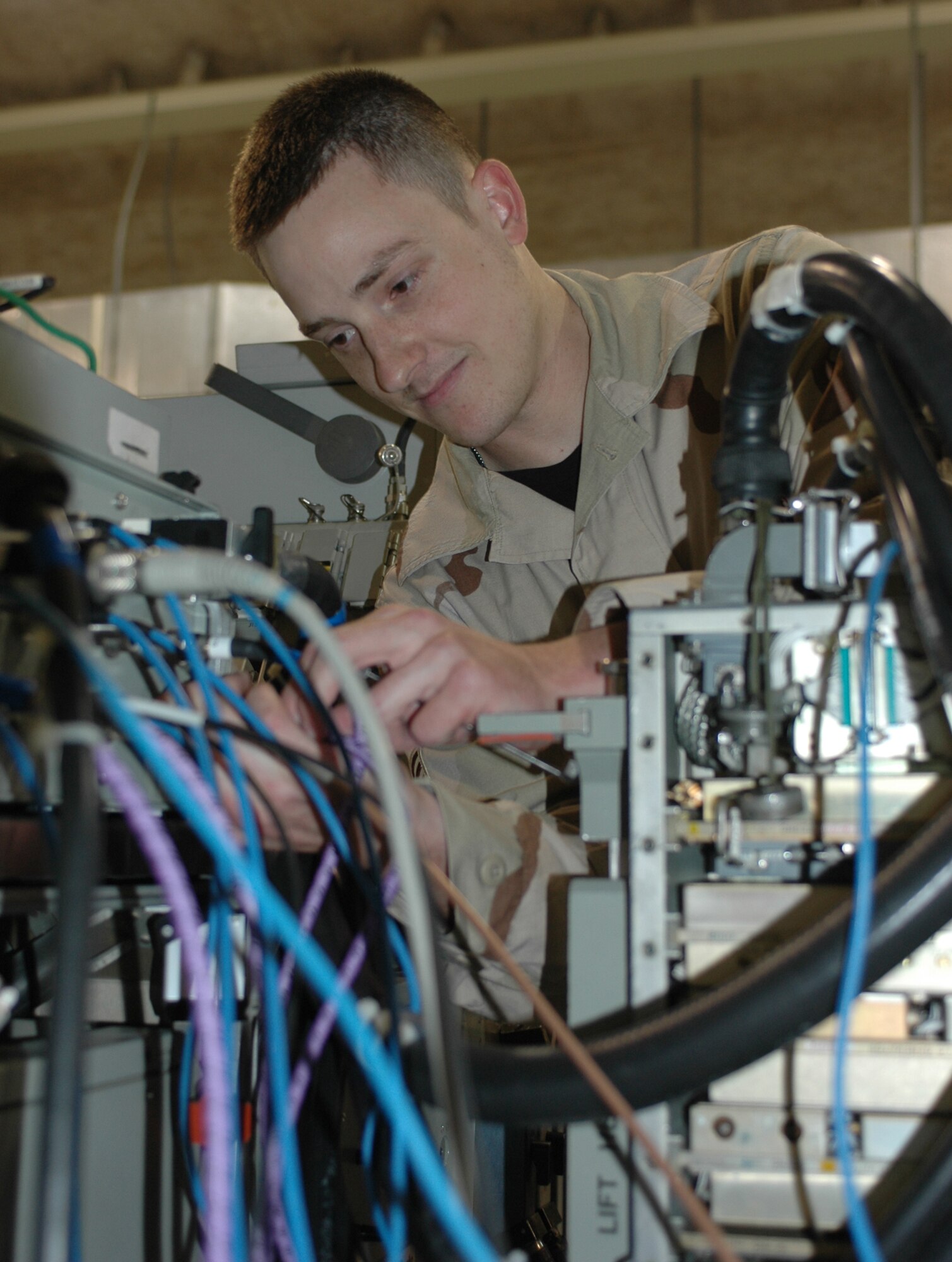 Senior Airman Ryan Burgess, 379th Expeditionary Maintenance Squadron   Avionics Flight team leader, makes adjustments during a radar receiver exciter test.  (U.S. Air Force photo/Staff Sgt. Jasmine Reif)