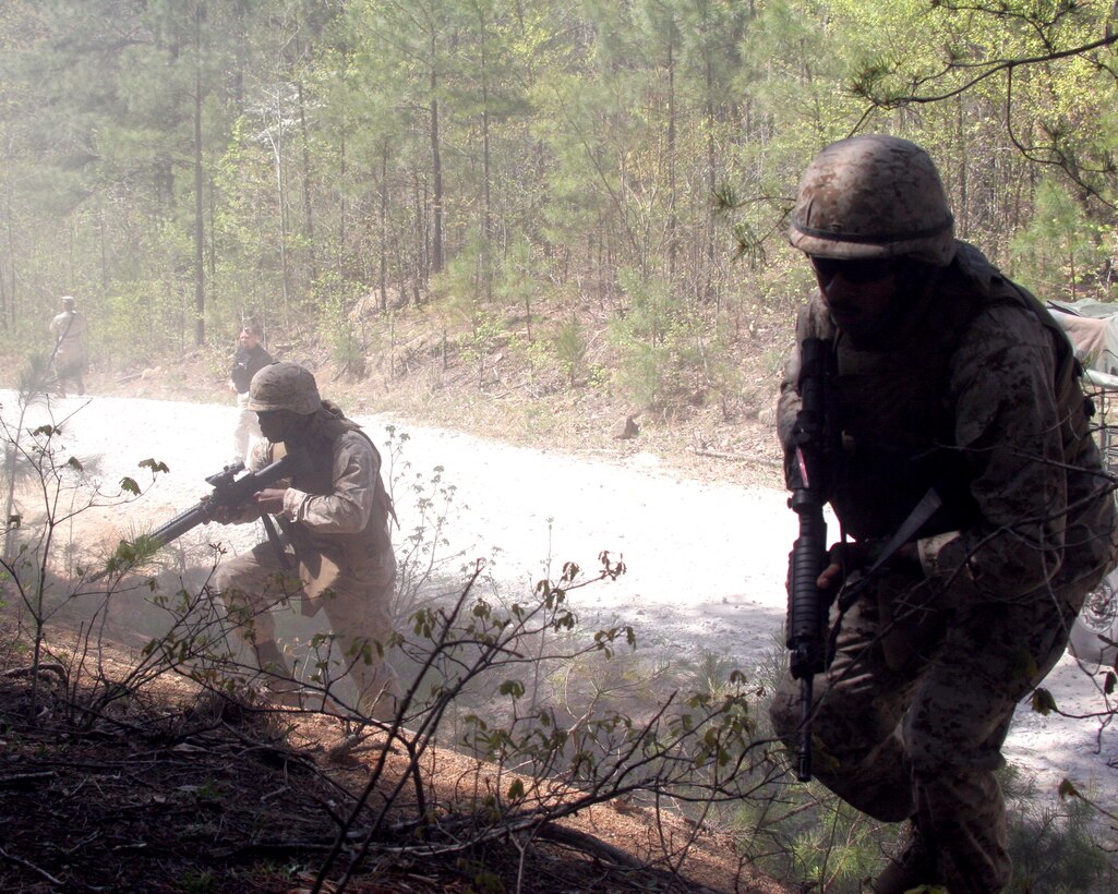 Marines with Battalion Landing Team, 3rd Battalion, 8th Marine Regiment, 22nd Marine Expeditionary Unit, take cover during an Improvised Explosive Device recognition training exercise aboard Fort Pickett, Va., April 21, 2007. The Marines were honing their skills in case they are faced with a real-life IED attack when they deploy as the as the Ground Combat Element for the 22nd Marine Expeditionary Unit later this year. (U.S. Marine Corps Photo by Sgt. Ezekiel R. Kitandwe)::n::