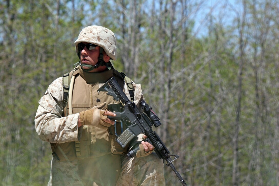 A Marine with Battalion Landing Team, 3rd Battalion, 8th Marine Regiment, provides security down a road during a training exercise held aboard Fort Pickett, Va., April 21, 2007. The Marines and sailors of BLT 3/8 are currently training for an upcoming deployment as the Ground Combat Element for the 22nd Marine Expeditionary Unit scheduled later this year.  (Official Marine Corps photo by Sgt. Ezekiel R. Kitandwe)::n::