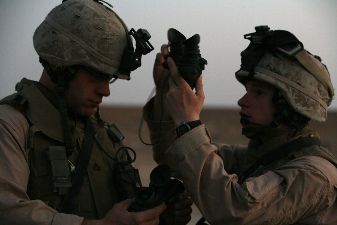 Lance Cpl. Beau Grezik, a landing support specialist with Transportation Support Company, Combat Logistics Battalion 2, helps Cpl. Shaun O-Brien, an air delivery specialist for TS Company, CLB-2, put on his Night Vision Goggles before an air delivery drop outside Controlled Observation Post Timberwolf, April 21.