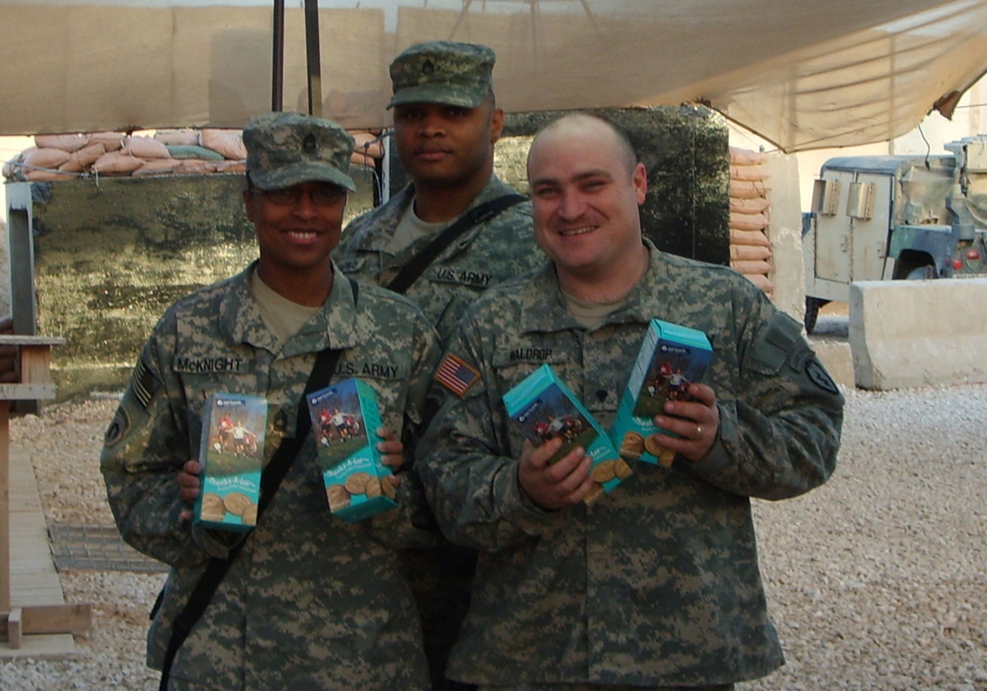 SOUTHWEST ASIA --  Soldiers deployed here show their boxes of Girl Scout cookies.  Brownies and Junior Girl Scouts at Osan Air Base sent 636 boxes of Girl Scout cookies to servicemembers in Iraq and Afghanistan thanks to the donations from Team Osan. (Courtesy photo)