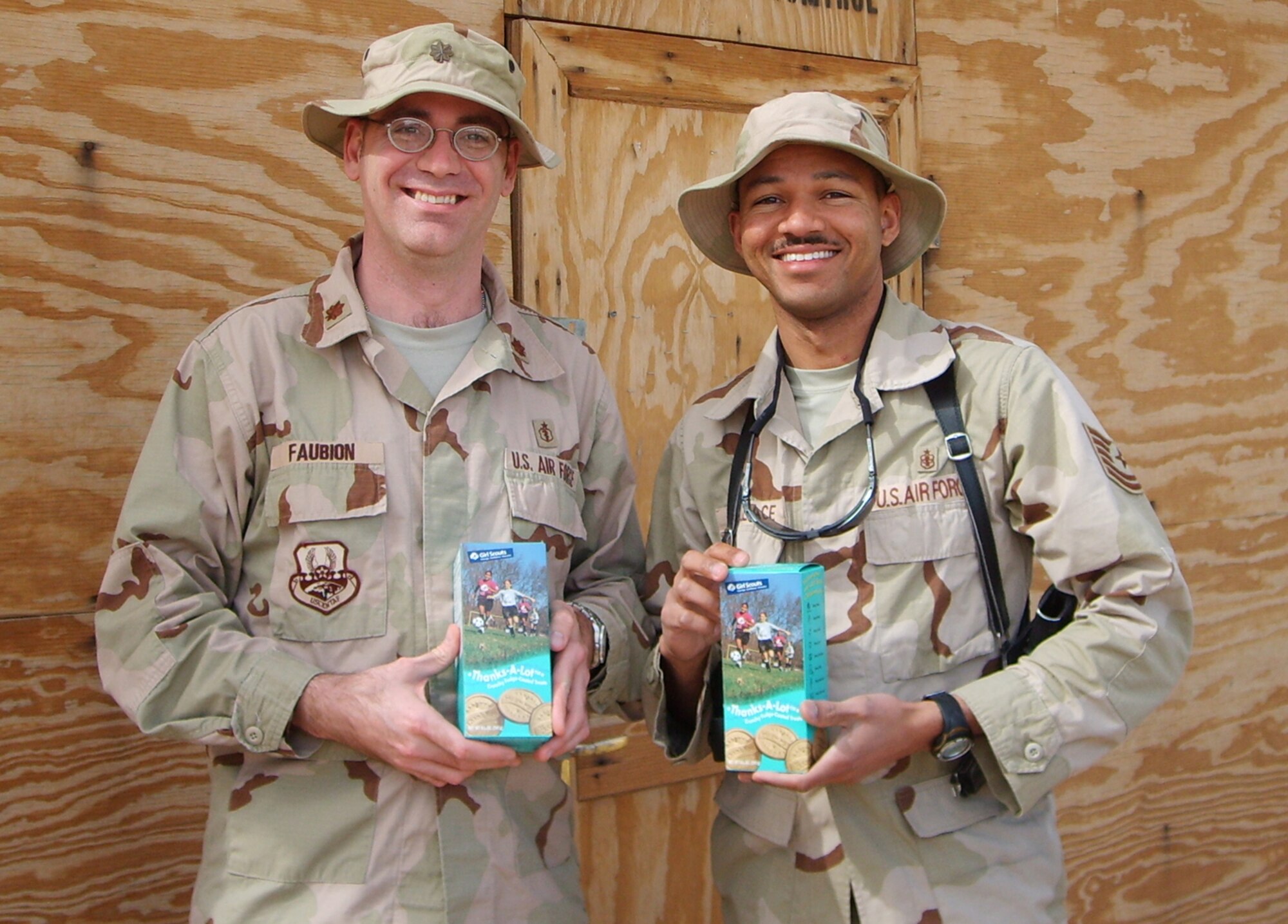 SOUTHWEST ASIA --  Maj. Matthew Faubion and Tech. Sgt. Randall Wallace show their boxes of Girl Scout cookies. The Brownies and Junior Girl Scouts at Osan Air Base sent 636 boxes of Girl Scout cookies to servicemembers deployed to Iraq and Afghanistan. (Courtesy photo)