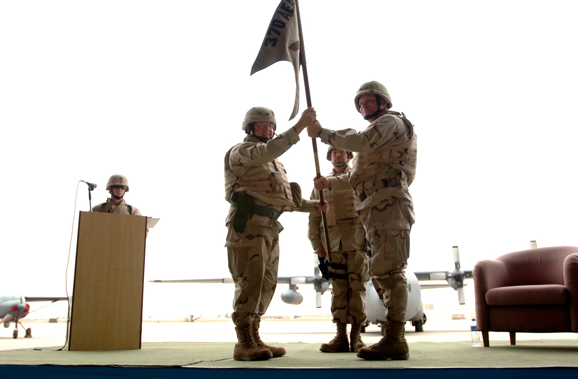 Baghdad, Iraq -- Col. Daniel G. Groeschen presents the 370th Air Expeditionary Advisory Squadron Unit flag to Col. Mark J. Schmitz during the Assumption of Command Ceremony at New Al Muthana Air Base April 22.  (U.S. Air Force photo/Tech. Sgt. Cecilio M. Ricardo Jr.) 