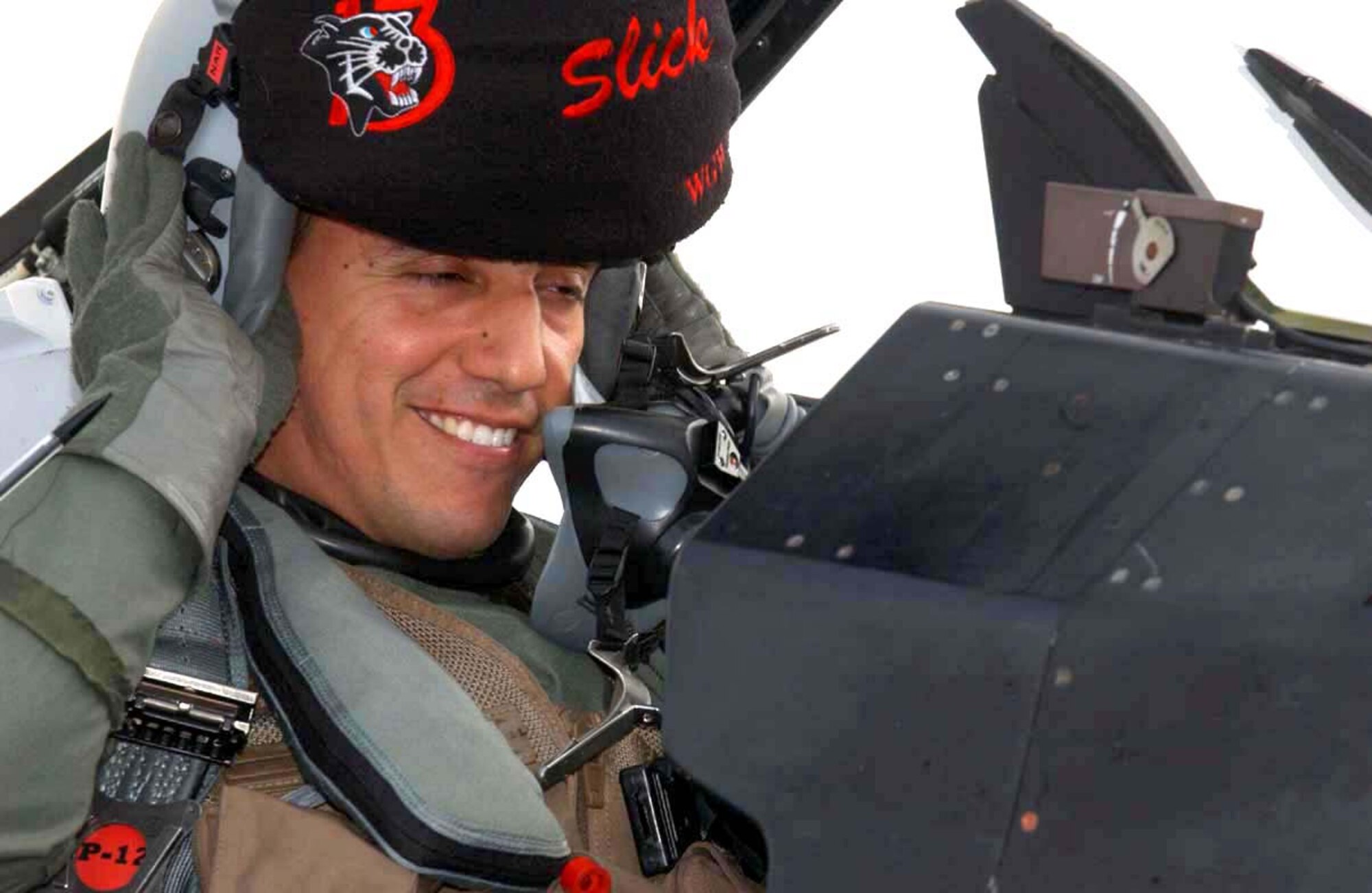 070413--MISAWA AIR BASE, Japan --Capt. Alfred Rosales, 13th Fighter Squadron pilot, puts on his helmet prior in preparation for a training mission here. The 13th Fighter Squadron is making final preparations for their Air Expeditionary Force deployment to Iraq this summer. The squadron will replace the 14th Fighter Squadron currently conducting combat operations in Iraq.  (U.S. Air Force photo by Senior Airman Robert Barnett)