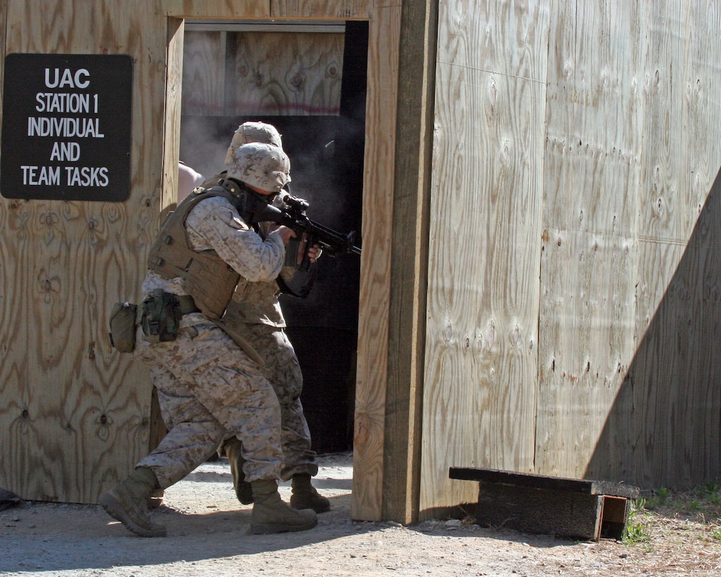 Marines with Weapons Platoon, Company I, Battalion Landing Team, 3rd Battalion, 8th Marine Regiment, 22nd Marine Expeditionary Unit, rush into a room during an urban assault-training course at Fort Pickett, Va., April 22, 2007. The training will help prepare the Marines for their upcoming deployment scheduled for later this year. (U.S. Marine Corps Photo by Sgt. Ezekiel R. Kitandwe)