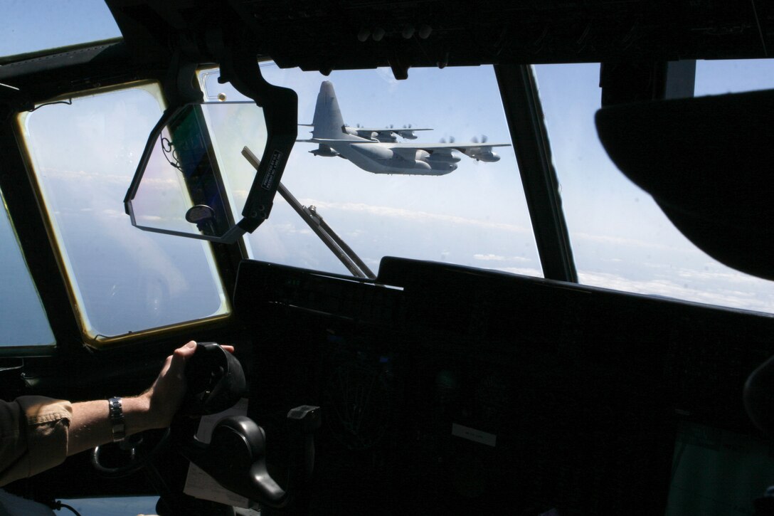 AL ASAD, Iraq - Lance Cpl. Melissa Losacker, a military working dog handler, and her canine partner, Karo, search recently vacated cans aboard Al Asad, April 23. The service members and their dogs at the Al Asad Military Working Dog kennel assist in making sure no drugs or explosives are brought onto the base.