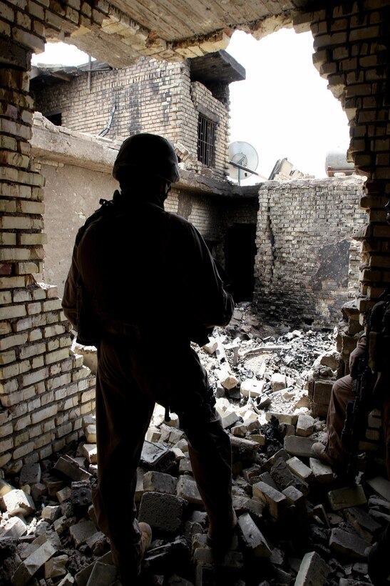 A Marine with Personal Security Detachment, 2nd Battalion, 6th Marine Regiment, assesses an area scheduled to be destroyed because of its former use as a weapons cache in Fallujah on April 22. Marines with PSD provide continual safe and successful travel for the battalion commander and his staff within 2/6’s area of operation. The battalion is currently conducting combat operations in support of Regimental Combat Team 6 in Al Anbar Province, Iraq. “These Marines are good at what they do,” said Staff Sgt. Jeffery S. Benkie, PSD platoon commander and 34-year-old Rio Vista, Calif., native. “We have made ourselves fully functioning because everyone contributes to the success of our team. Our accomplishments don’t rest on one single Marine, but the entire group.”