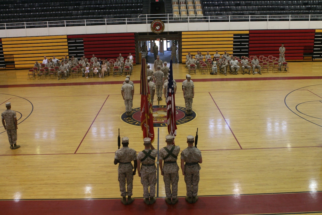 A color detail stands at attention as Sgt. Maj. Brett Sheuer and Sgt. Maj. Douglas Schaefer prepare to change commands, July 8, 2011 at the Goettge Field House, aboard Marine Corps Base Camp Lejeune, N.C. During the ceremony, Sheuer relinquished his command to Schaefer.