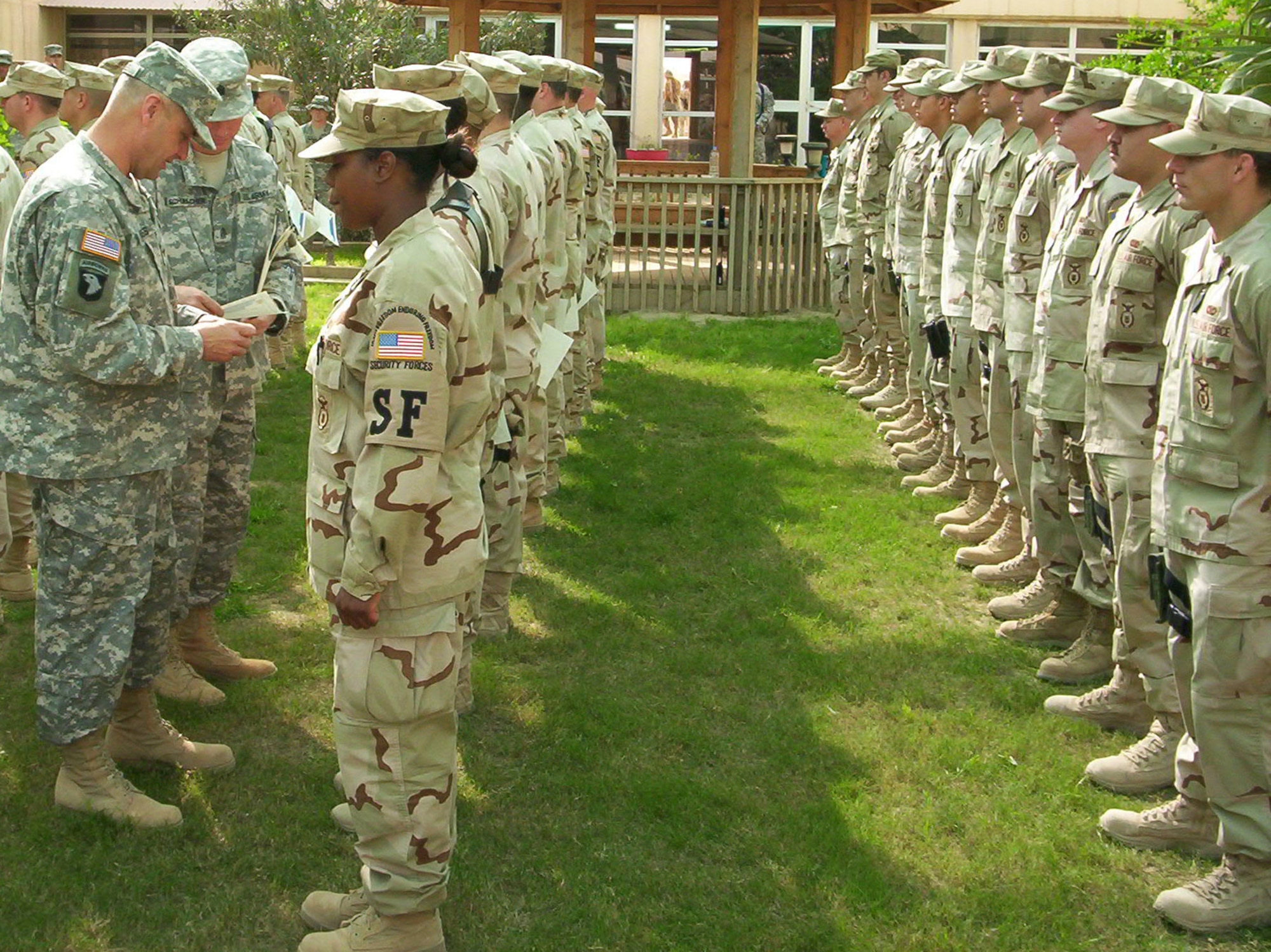 TIKRIT, Iraq -- Army Col. Charles Jones, 149th Armor Brigade garrison commander, and Garrison Command Sgt. Maj. Eric Schumaker present the 149th Armor Brigade’s combat patch to members of the 732nd Expeditionary Security Forces Squadron in Iraq during a ceremony earlier this month. The Army-unique ceremony recognized 43 Airmen from Mountain Home and three other Air Force bases who deployed to Tikrit in November to take on various Army military police duties. Air Force photo