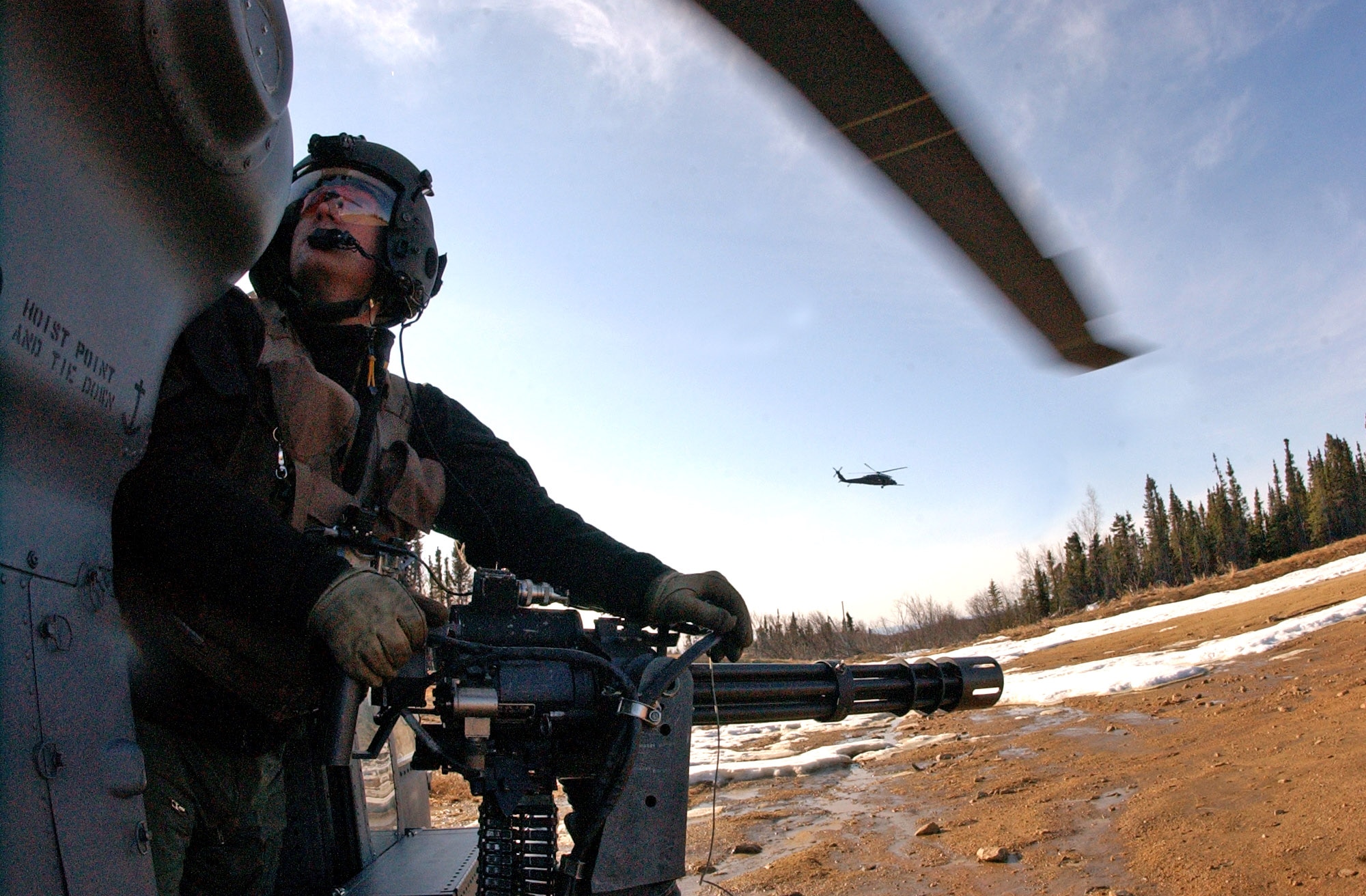 Staff Sgt. Dave Torrance scans the area for enemy threats aboard an HH-60G Pave Hawk helicopter April 17 while manning a 7.62mm minigun at Eielson Air Force Base, Alaska. Red Flag-Alaska exercises help enhance combat training for U.S. military and coalition forces. Sergeant Torrance is a 210th Rescue Squadron Det. 1 flight engineer. (U.S. Air Force photo/Senior Airman Justin Weaver)