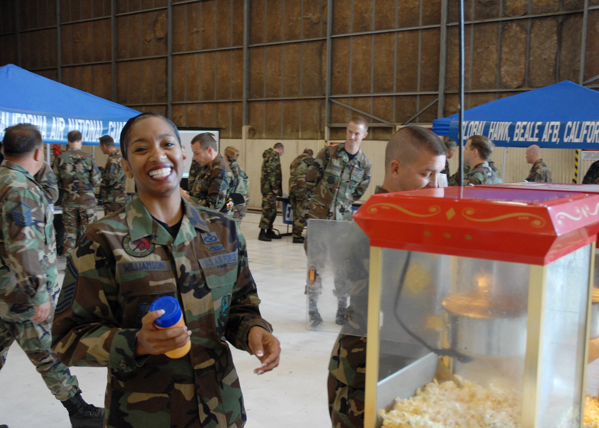 Senior Master Sgt. Charisse Williamson, flight management superintendent for the 314th Air Refueling Squadron, and Master Sgt. C.P. Kline, first sergeant of the 940th Operations Support Flight, make popcorn for Airmen attending BRAC job fair at Beale Air Force Base, Calif., April 15, 2007. The event was developed by supervisors from the Air Force Reserve Command's 940th Air Refueling Wing. (U.S. Air Force photo/Maj. Robert Couse-Baker)
