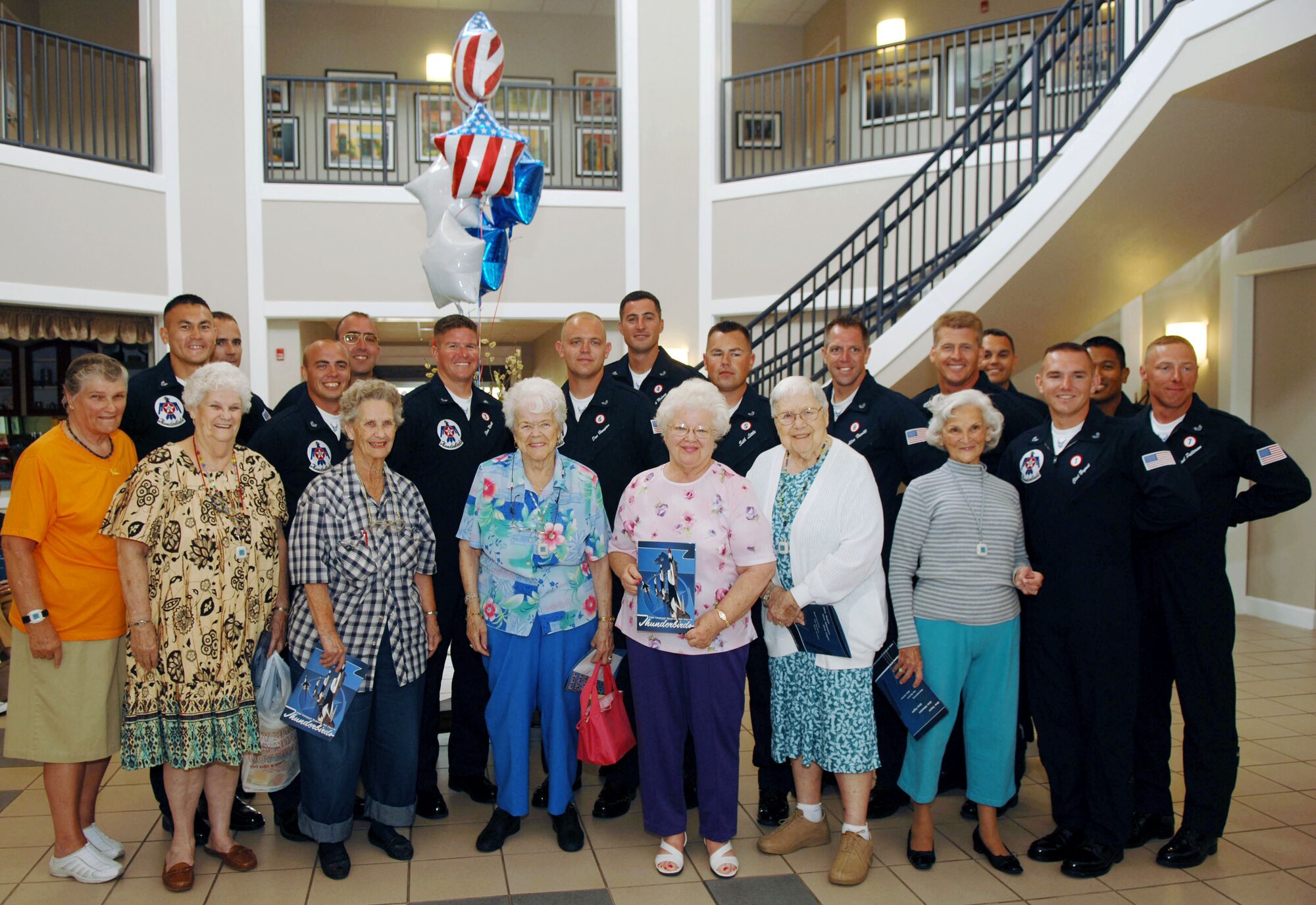 Aircrew members of the Thunderbirds, the Air Force's air demonstration team, visit with residents at Hawthorn House, the Air Force Enlisted Village's assisted living residence in Shalimar, Fla. When inclement weather caused the Eglin Air Show to be cancelled April 14, the Thunderbirds made a surprise visit to the Enlisted Village, a charity that provides a home for widows of enlisted servicemembers. (Courtesy photo)