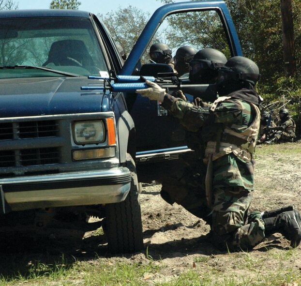 During a combat training scenario, ECST students work to fend off an ambush next to their broken down vehicle. (U.S. Air Force photo by 2nd Lt. Lauren Johnson)