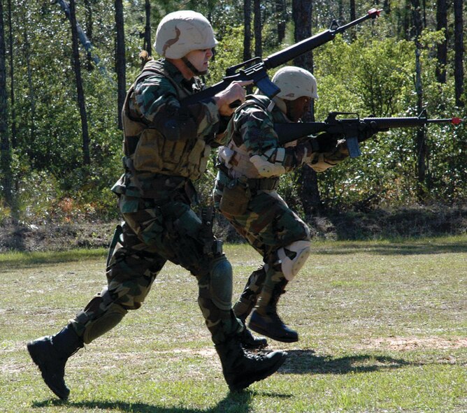 Two Expeditionary Combat Skills Training students advance through the field during the most recent class at Hurlburt April 11-13. (U.S. Air Force photo by 2nd Lt. Lauren Johnson)