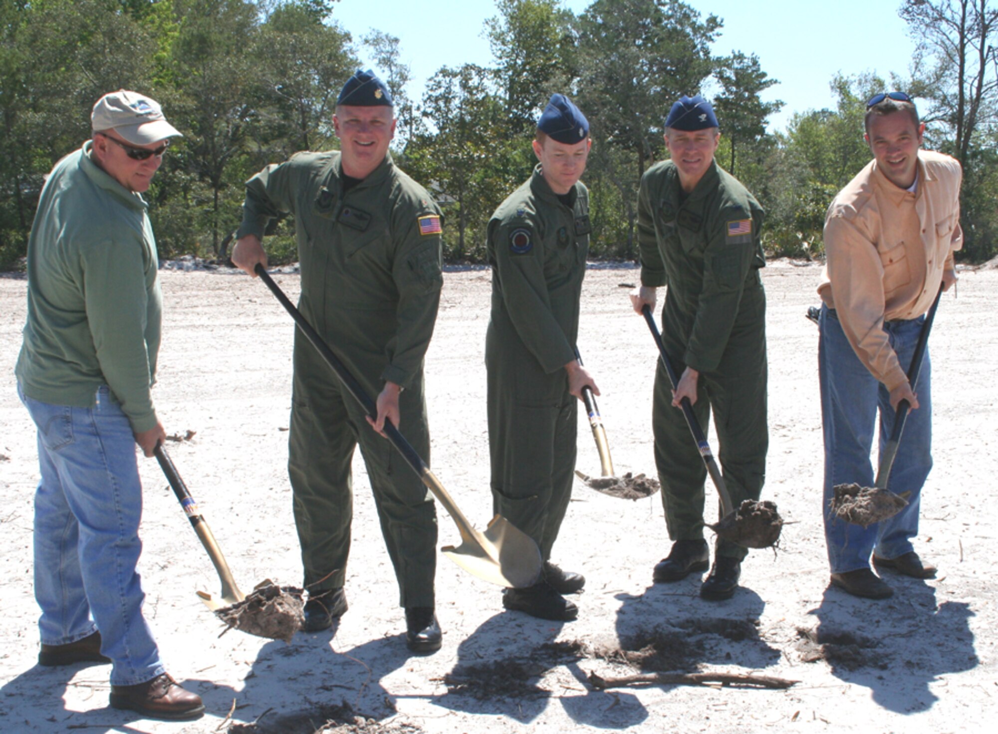 The 1st Special Operations Support Squadron broke ground April 16 on a new facility for the opposition forces unit. Shown left to right are Jeffrey Morrison, OPFOR supervisor, Maj. Samuel Osborne, 1st SOSS assistant director of operations, Lt. Col. BIll West, 1st SOSS commander, Col. Mark Alsid, 1st Special Operations Group commander, and Spike Lord, Lord and Son Construction. (U.S. Air Force photo by Staff Sgt. Angela Shepherd)