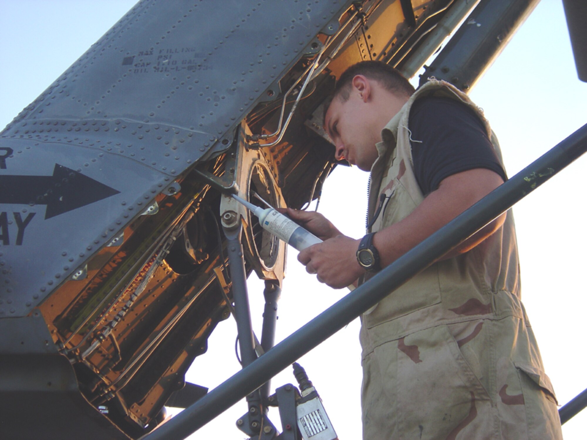 Staff Sgt. Sean Kasperek, 1st Special Operations Helicopter Maintenance Squadron, works on a helicopter in a deployed location. (Courtesy photo)