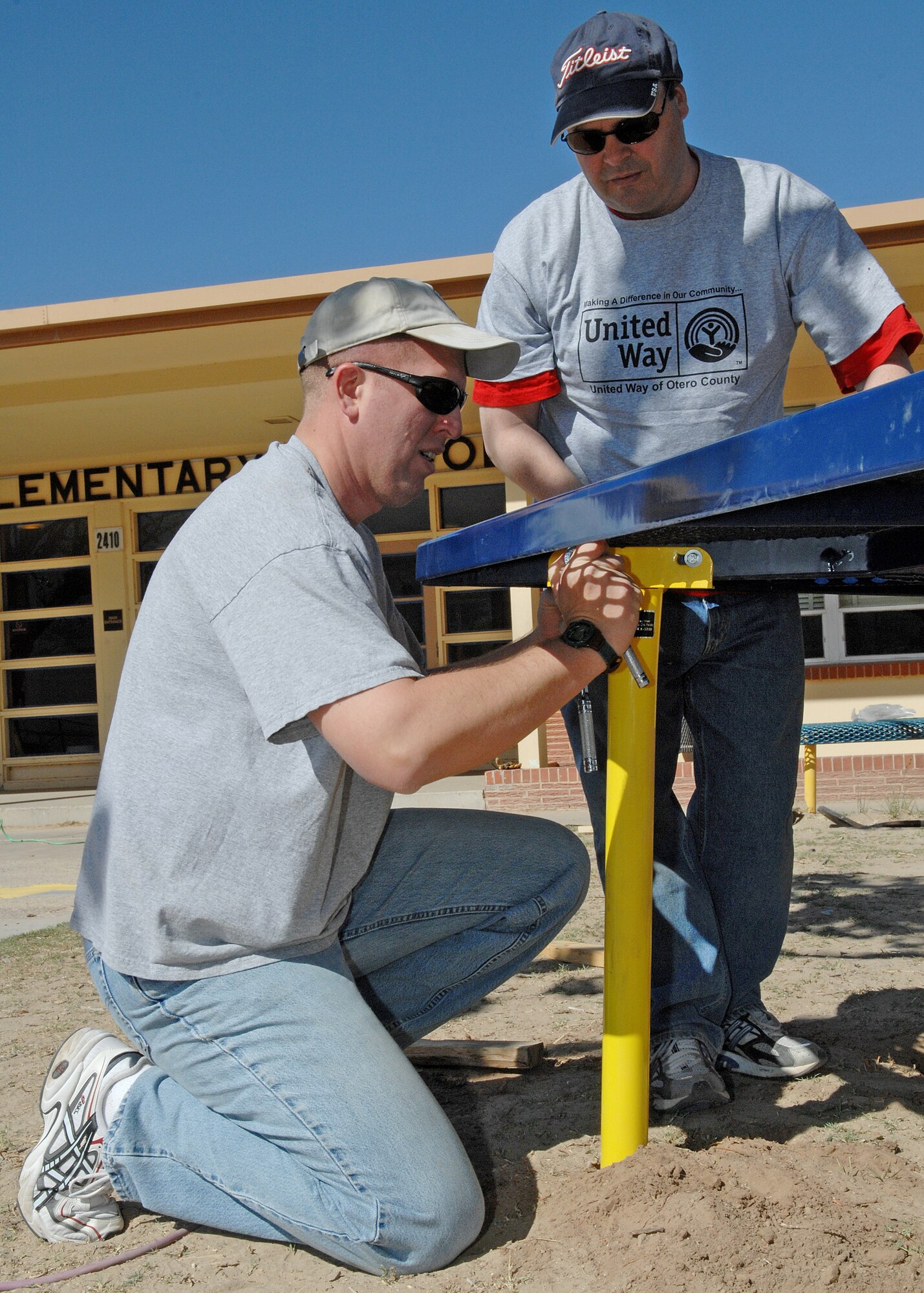Two Team Holloman members do some handy work in the Day of Caring event put  together by the United Way of Otero County. 95 to 98 percent of the Day of Caring volunteers were a part of Team Holloman. (U.S. Air Force photo by Airman 1st Class John Strong)