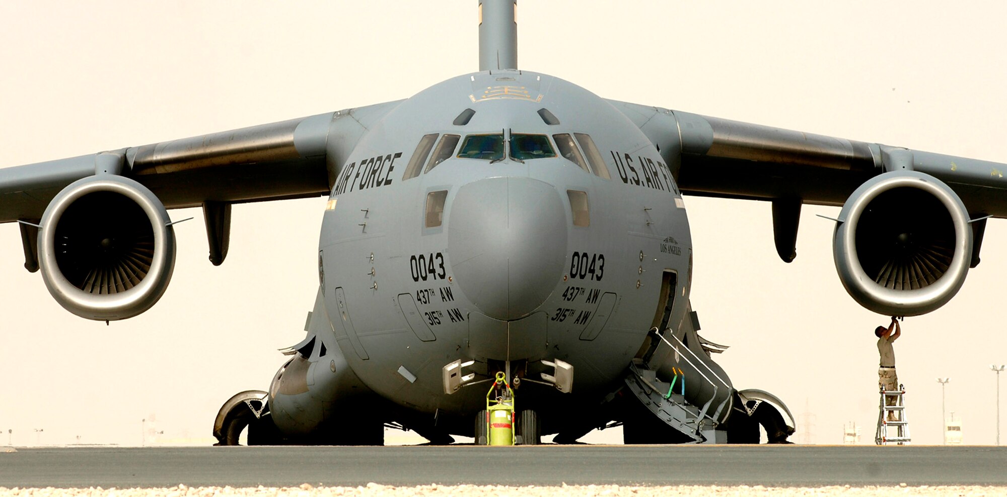 A maintenance Airman checks a C-17 Globemaster III prior to a support mission in Iraq.  C-17s provide intra-theater heavy airlift support.  (U. S. Air Force photo/Tech. Sgt. Cecilio M. Ricardo Jr.) 