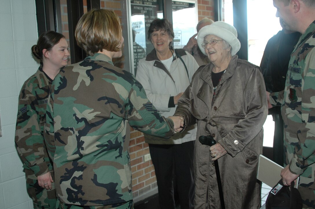 Marygertrude Bellamy is greeted by the Bellamy Fitness Center staff. This was her first visit since the fitness center was named after her brother, Lt. Paul Herbert Bellamy, in 1957. Leutenant Bellamy died in England while flying a B-17 mission during World War II. Mrs. Bellamy, 91, taught in Rapid City for eight years of her 16-year career and is the only surviving member of the six-sibling family. (U.S. Air Force photo/Airman 1st Class Kimberly Moore Limrick)