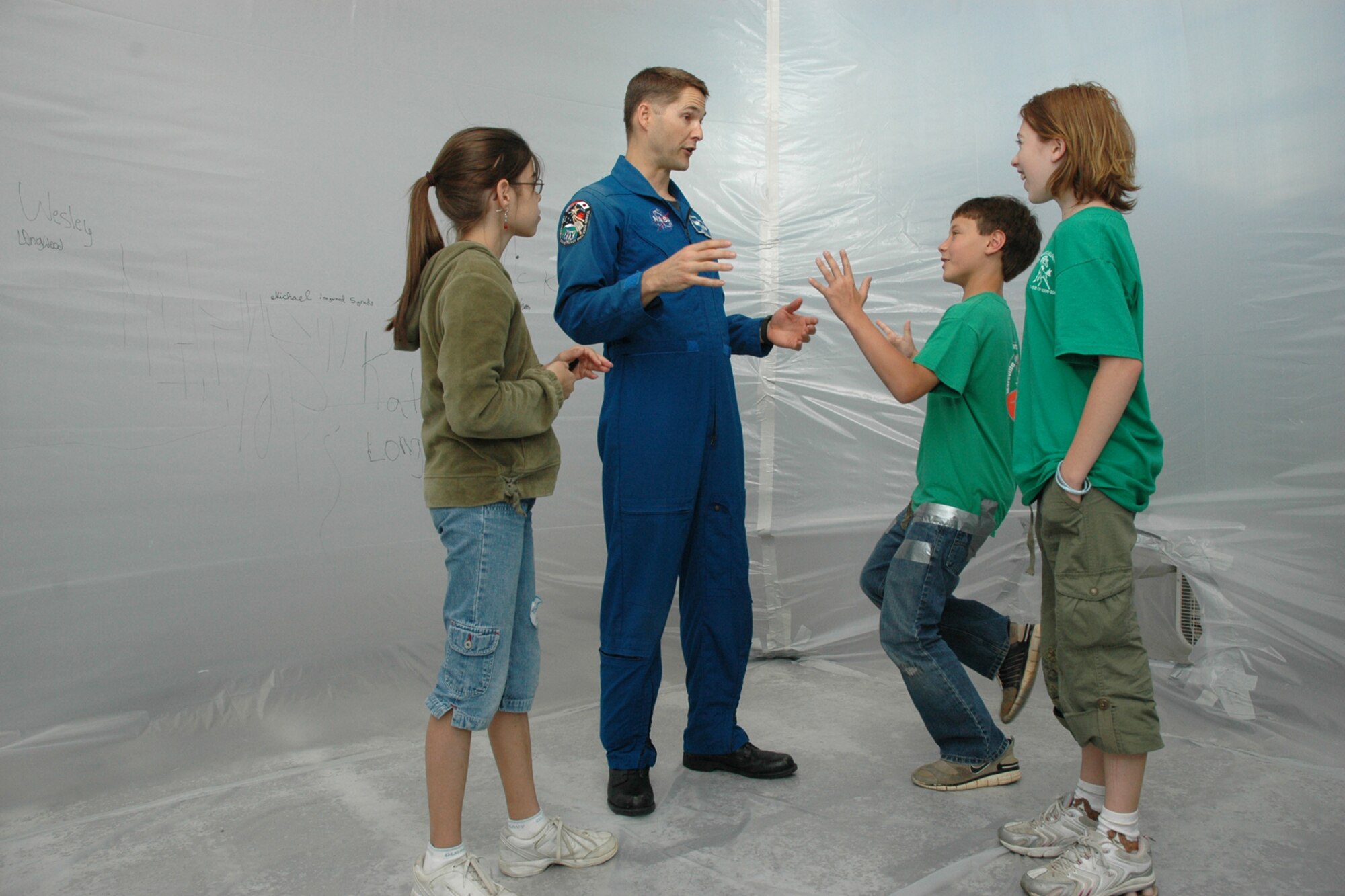 EGLIN AIR FORCE BASE, Fla. -- Air Force Lt. Col. Jim Dutton, a NASA astronaut, speaks to students from Valparaiso and Longwood elementary schools about the conditions of living in space during Marsville April 20 inside Hangar 110. Fifth-grade students from three elementary schools kicked off the Marsville Project culminating six weeks of study about space. The project required students from Cherokee, Valparaiso and Longwood Elementary Schools to experience a day of living in "space" by building a habitat. During the weeks prior to Marsville, students learned about the life support systems to consider before travel into space, such as the need for air, water, transportation and garbage disposal. Each student built a life support system model to bring with them. (U.S. Air Force photo by Staff Sgt. Mike Meares)