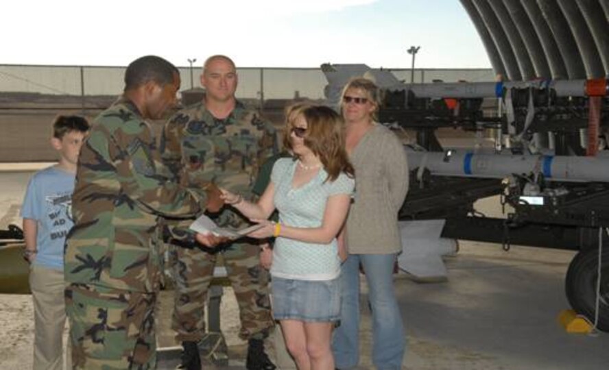 Chief Master Sgt. Booker Woods, 325th Maintenance Group, presents Stephanie Fields the Chief Master Sgt. Kebil Memorial Scholarship. Ms. Fields is the 2007 scholarship recipient, and is currently a college freshman studying elementary education at Gulf Coast Community College.