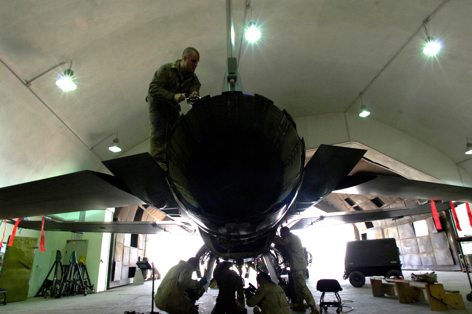 Staff Sgt. Justin Johnson removes screws from the rudder of an F-16 Fighting Falcon April 16 at Balad Air Base, Iraq. Sergeant Johnson is assigned to the 332nd Expeditionary Maintenance Squadron as a phase inspection team member. He is deployed here from the 35th Aircraft Maintenance Squadron at Misawa AB, Japan. (U.S. Air Force photo/Airman 1st Class Nathan Doza) 