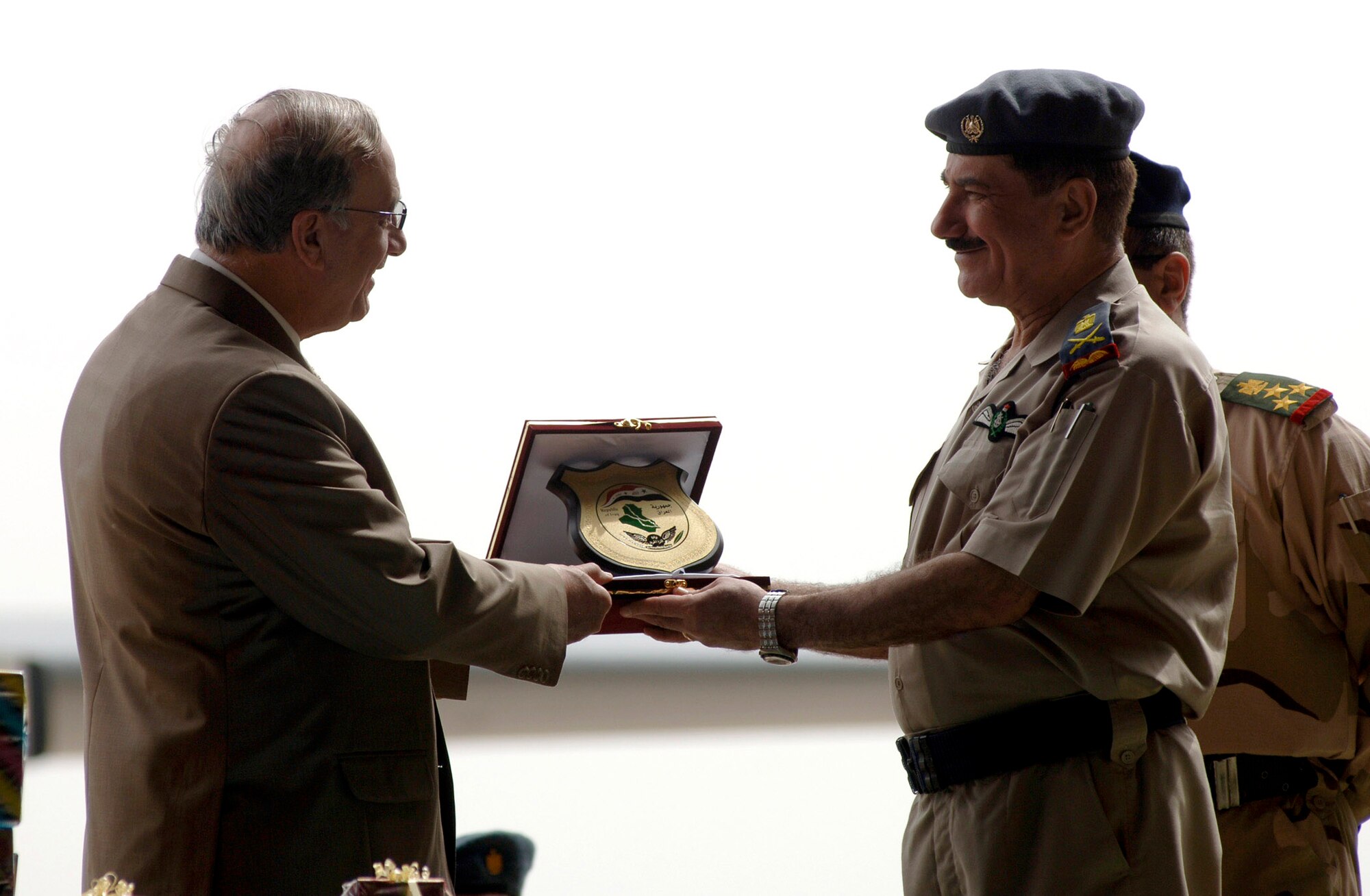 Brig. Gen. Abdul Kareem, New Al Muthana Air Base commander presents the Iraqi Minister of Defense Abd al-Qadir al-Mufriji with a plaque of appreciation April 22 during the celebration of the 76th anniversary of the Iraqi air force at the New Al Muthana Air Base in Baghdad, Iraq. (U.S. Air Force photo/Tech. Sgt. Cecilio M. Ricardo Jr.)