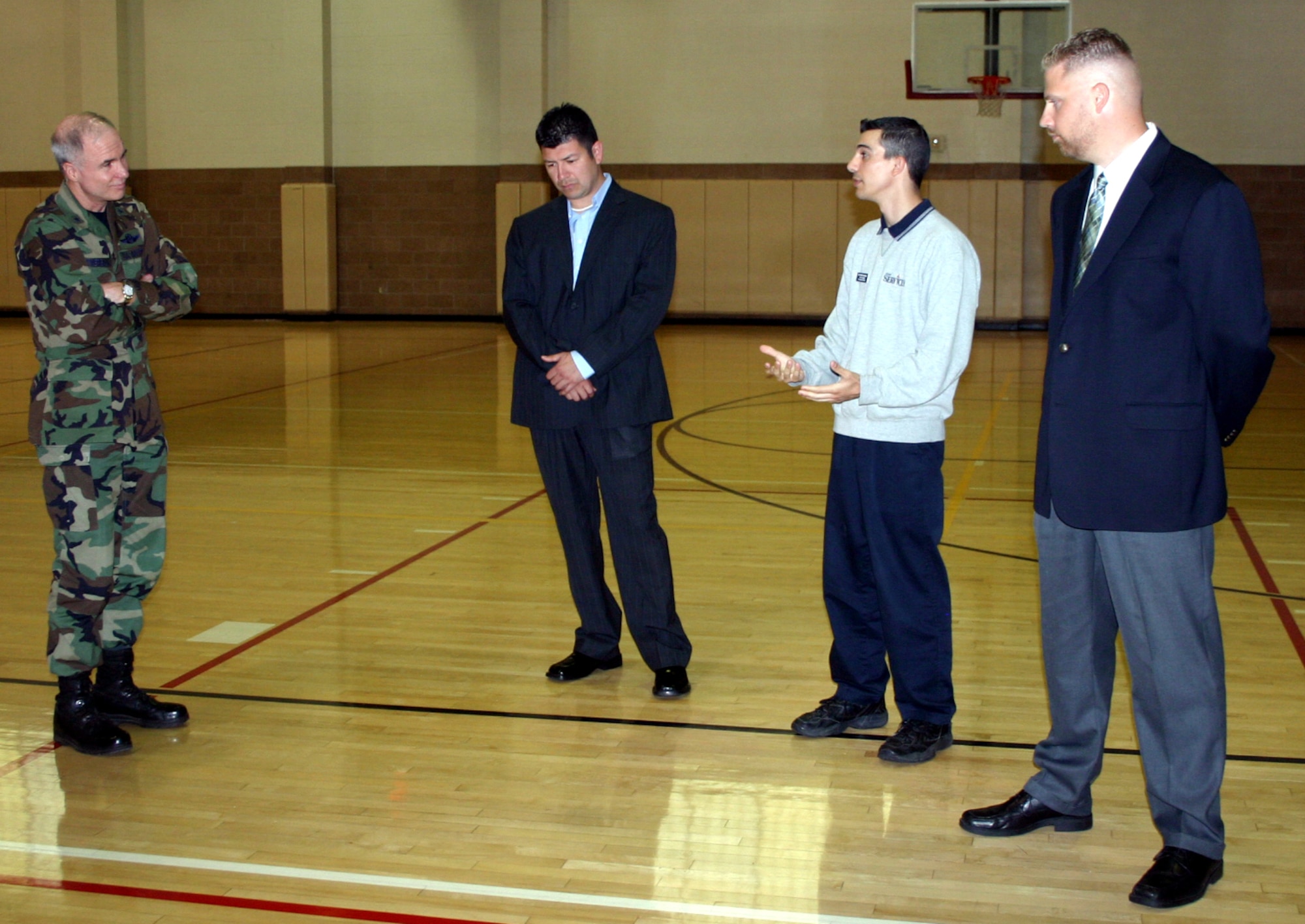 82nd Training Wing Commander Brig. Gen. Richard Devereaux listens as Senior Airman Christopher Coniglio, flanked by OSI Special Agent Fernando Martinez and Special Agent Frank Mosura, relates the story of how the three men saved the life of another OSI agent at the Levitow Fitness Center April 18. (U.S. Air Force photo/Staff Sgt. Tonnette Thompson)