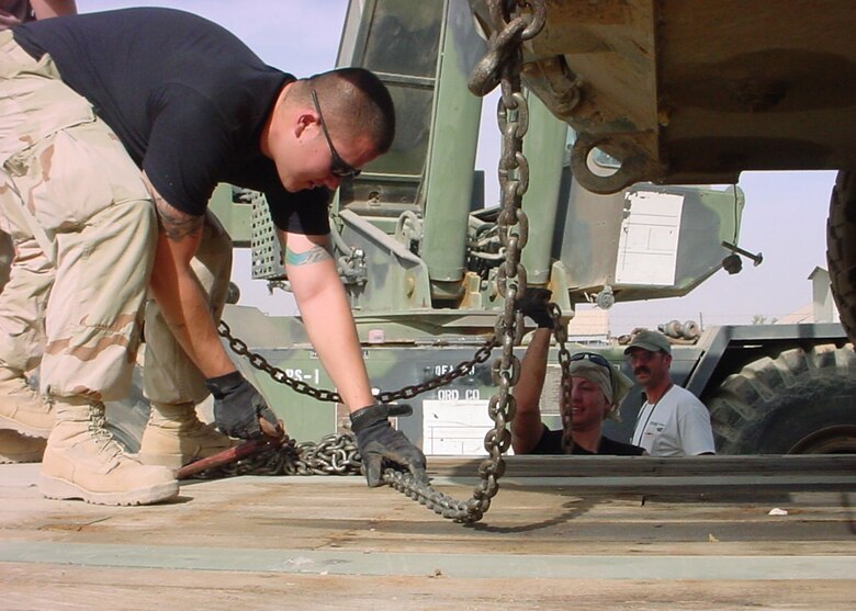 Senior Airman Michael Lawrence, 374 Logistics Readiness Squdron, performs routine maintenance on a vehicle before leavingon a convoy duty. Airman Lawrence earned the Air Force Transportation Airman of the Year.( Courtsey photo)