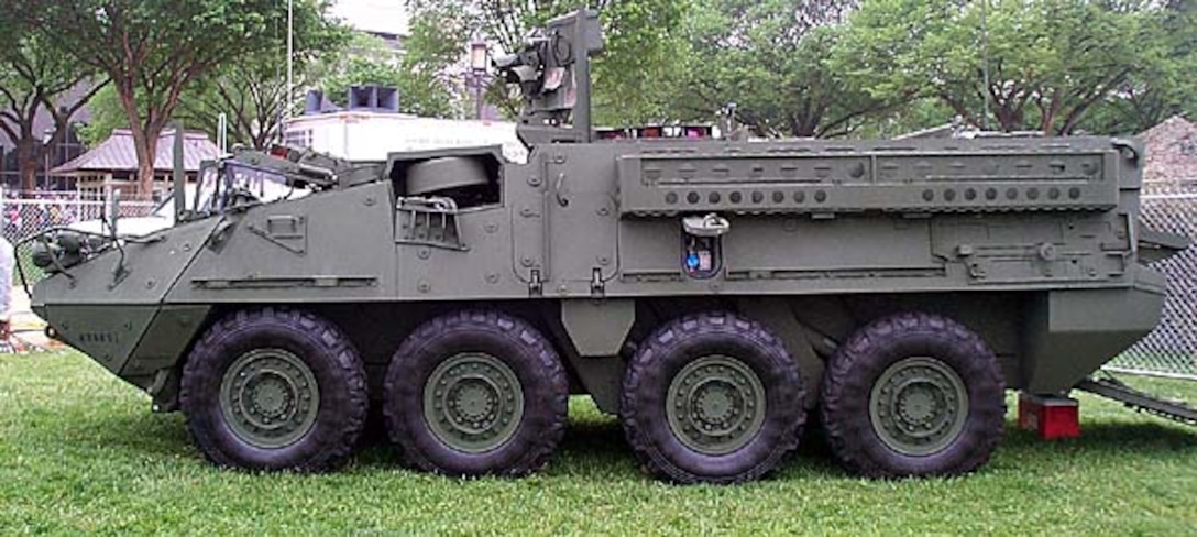 The rubber-tired Stryker weighs 38,000  pounds, can mount a machine gun, grenade launcher, or a  105mm cannon, and can travel more than 60 mph on hard roads  and maintain 45 mph cross-country. Photo by Gerry J.  Gilmore