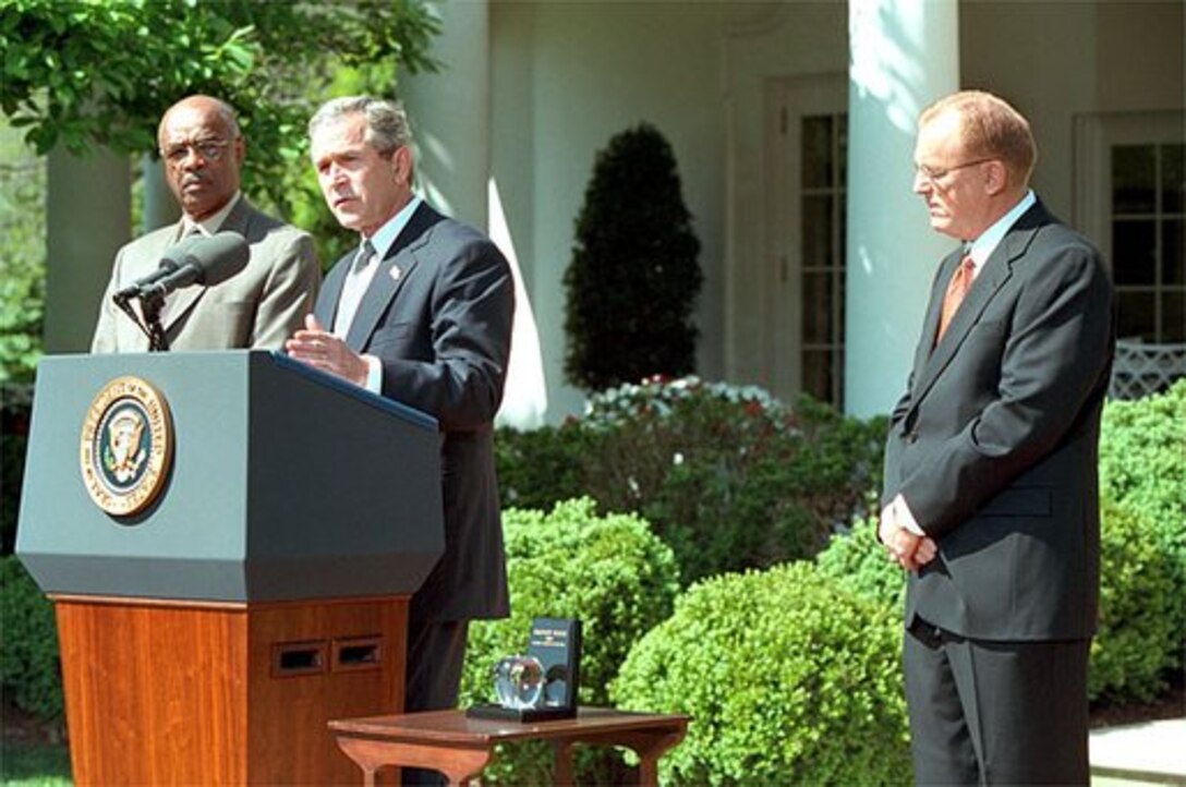 President George W. Bush and Secretary of  Education Rod Paige present the 2002 Teacher of the Year  award to Chauncey Veatch, right, in the Rose Garden at the  White House Wednesday, April 24. Mr. Veatch is a social  studies teacher at Coachella Valley High School in Thermal,  Calif., White House photo by Paul Morse.