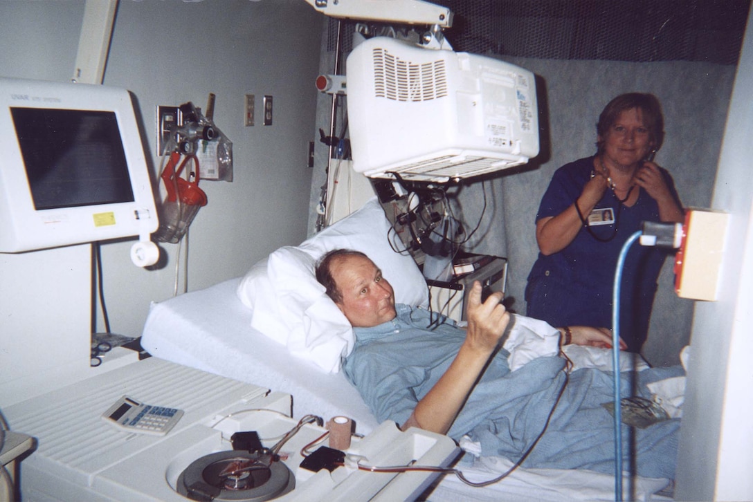 Navy Capt. John Pasko undergoes one of his monthly photophoresis treatments, meant to prevent his body from rejecting lung transplants he'd received from two Navy comrades on July 9, 2001. All three men are in advanced recovery. Pasko's unusual live-donor lung transplant experience will be retold March 20 on The Discovery Health Channel program "Super Surgery." Photo courtesy the Pasko family. 