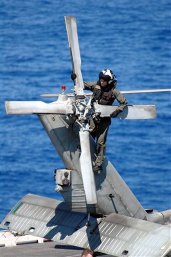 A U.S. Navy aircrewman performs a preflight rotor check on an HH-60H Seahawk helicopter on the flight deck of USS Ronald Reagan (CVN 76) on April 5, 2007.  The Ronald Reagan Carrier Strike Group is supporting maritime security operations in the Western Pacific.  