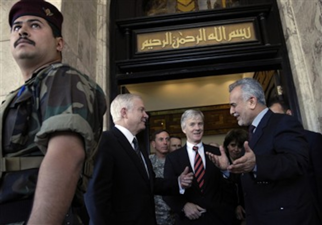 Secretary of Defense Robert M. Gates (2nd from left) speaks with Iraqi Vice President Tariq al-Hashimi (right) after meeting with Iraqi leadership at the Presidential Palace in Baghdad, Iraq, on April 20, 2007.  Gates is urging the Iraqi officials to speed up national reconciliation among the country's various factions in order to progress toward justice and reconciliation in Iraq.  U.S. Ambassador to Iraq Ryan Crocker (center) joined Gates in the meetings with Iraqi officials.  